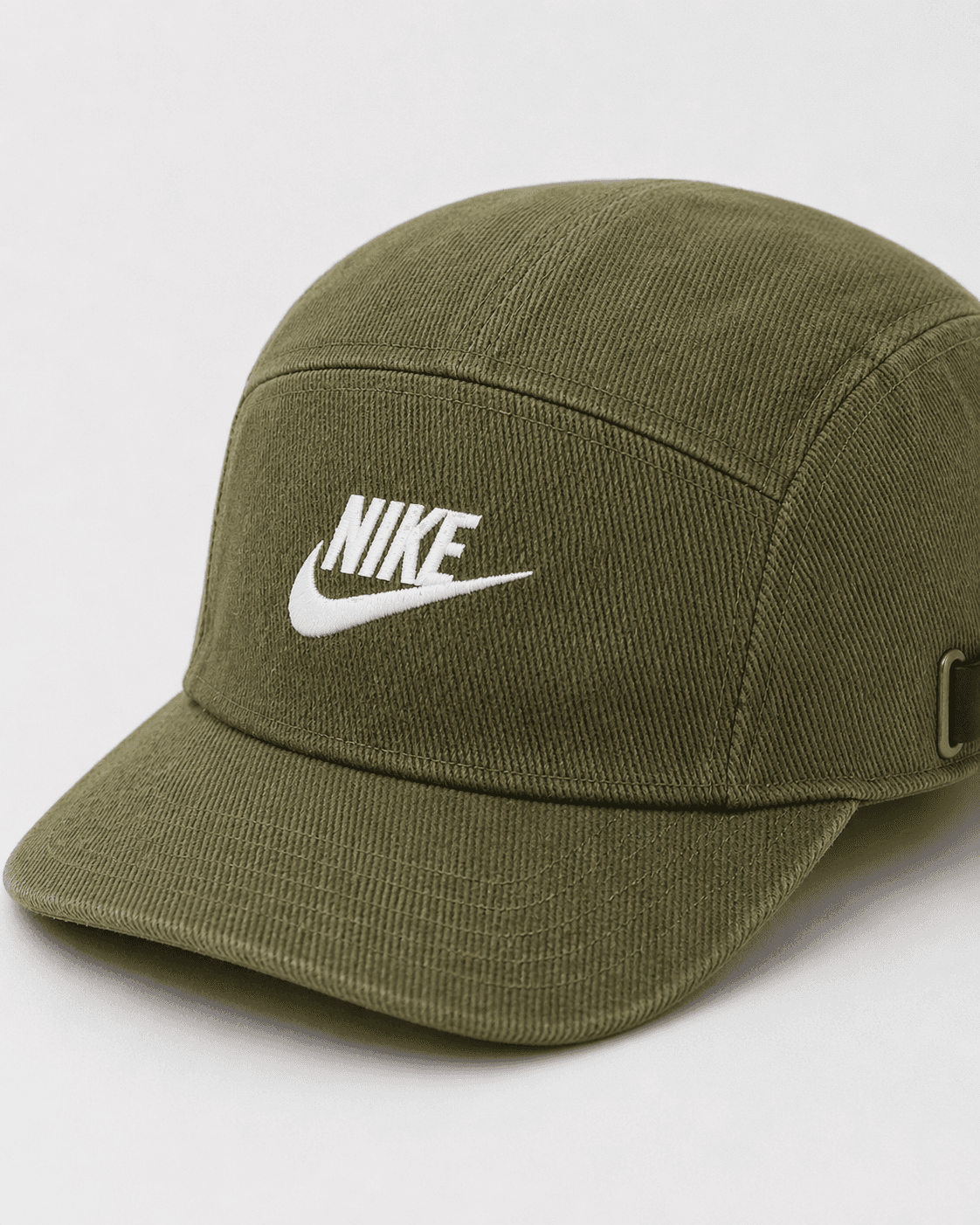 Green Nike cap on a light gray background