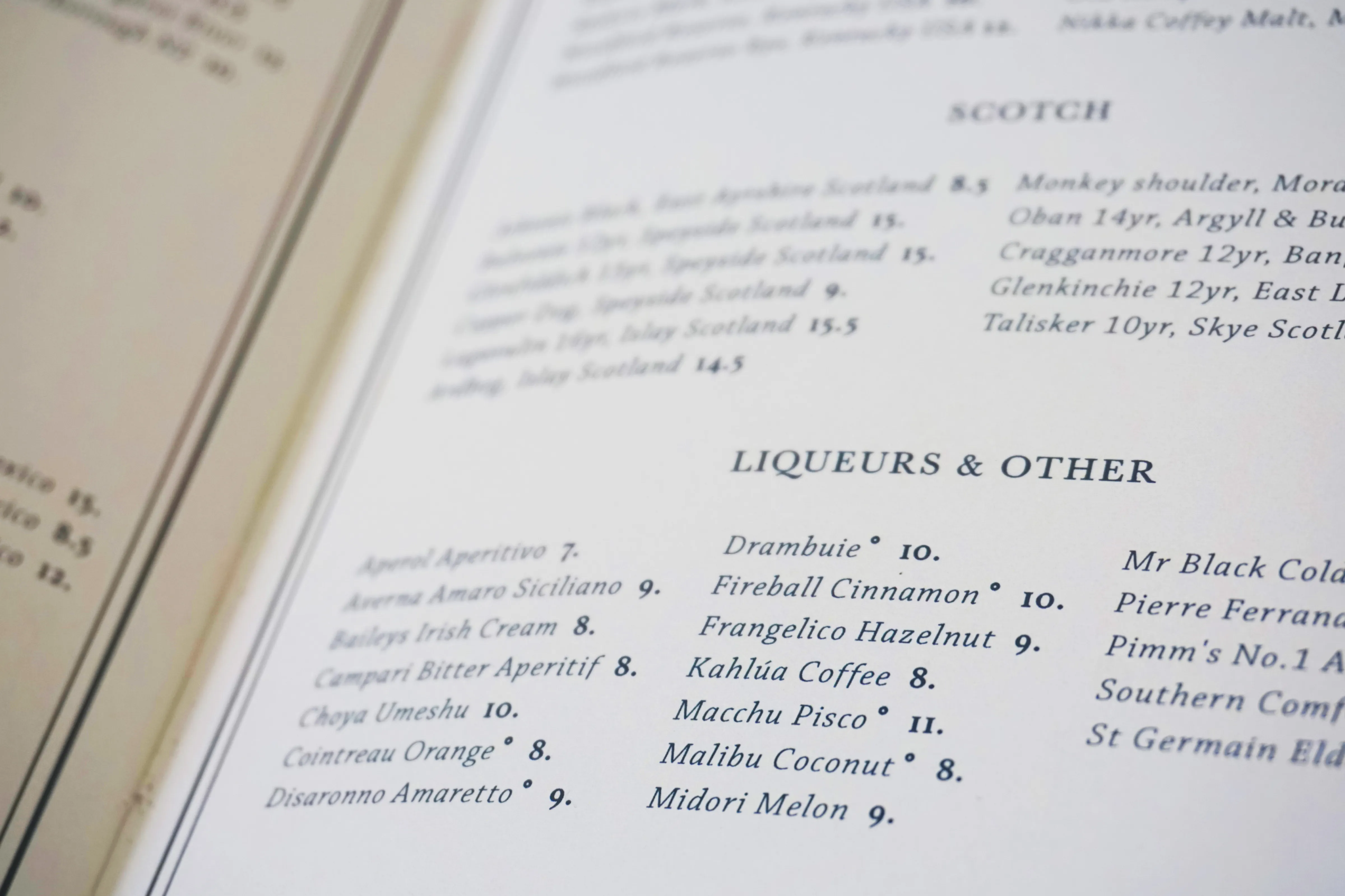 Close-up of the Small Bar spirits menu showing Scotch and Liqueurs in navy serif type