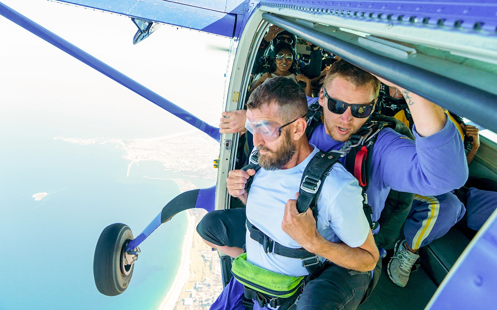 Paracadutista e istruttore alla porta dell'aereo pronti a saltare su Wollongong, Sydney.