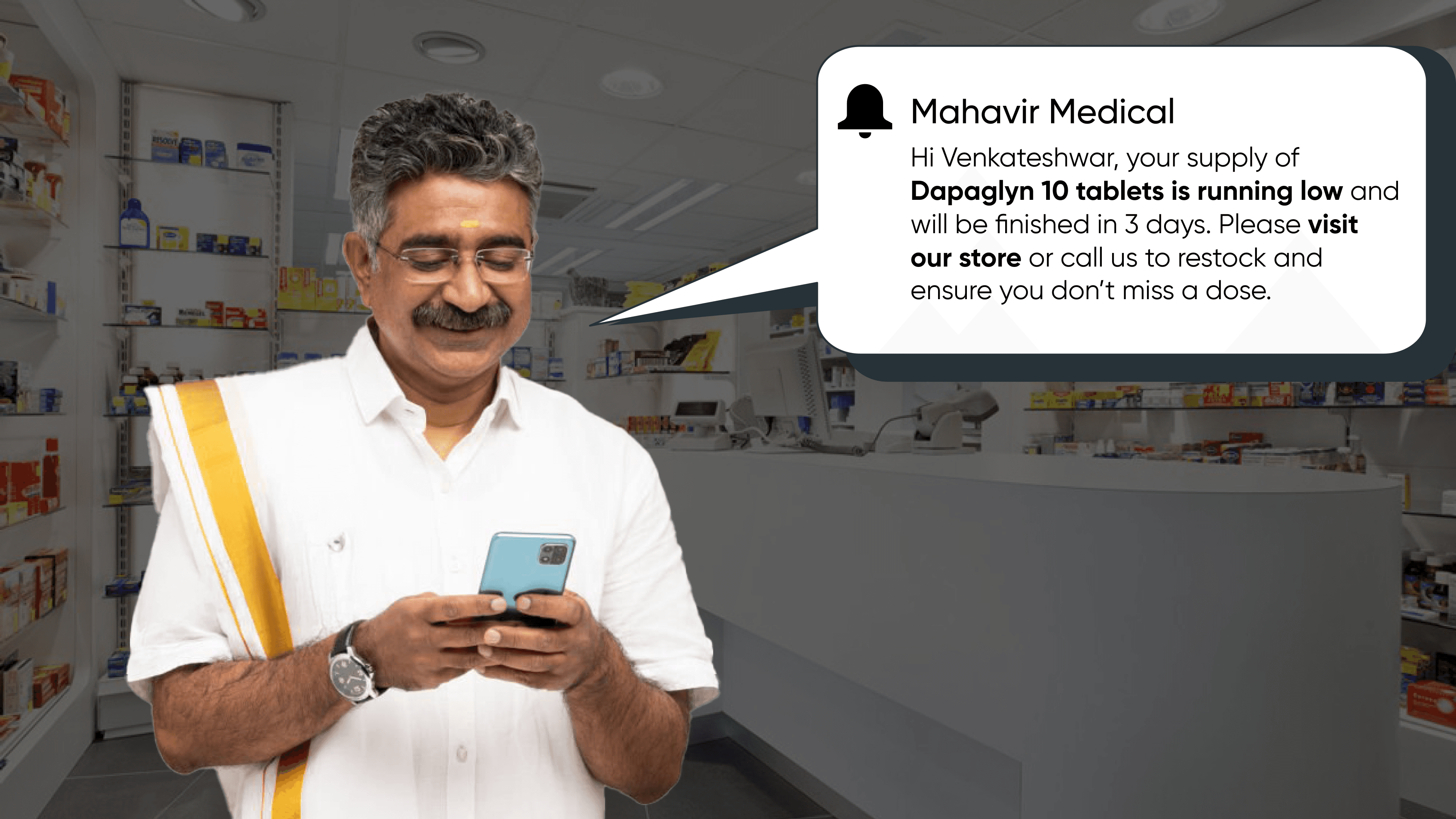 Indian pharmacist receiving an automated medicine refill reminder from Mahavir Medical on his phone