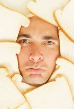 man's face surrounded with bread