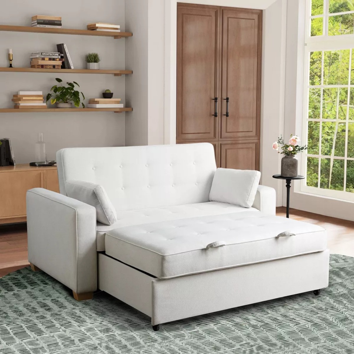 Light gray sofa bed in a modern room with built-in shelving