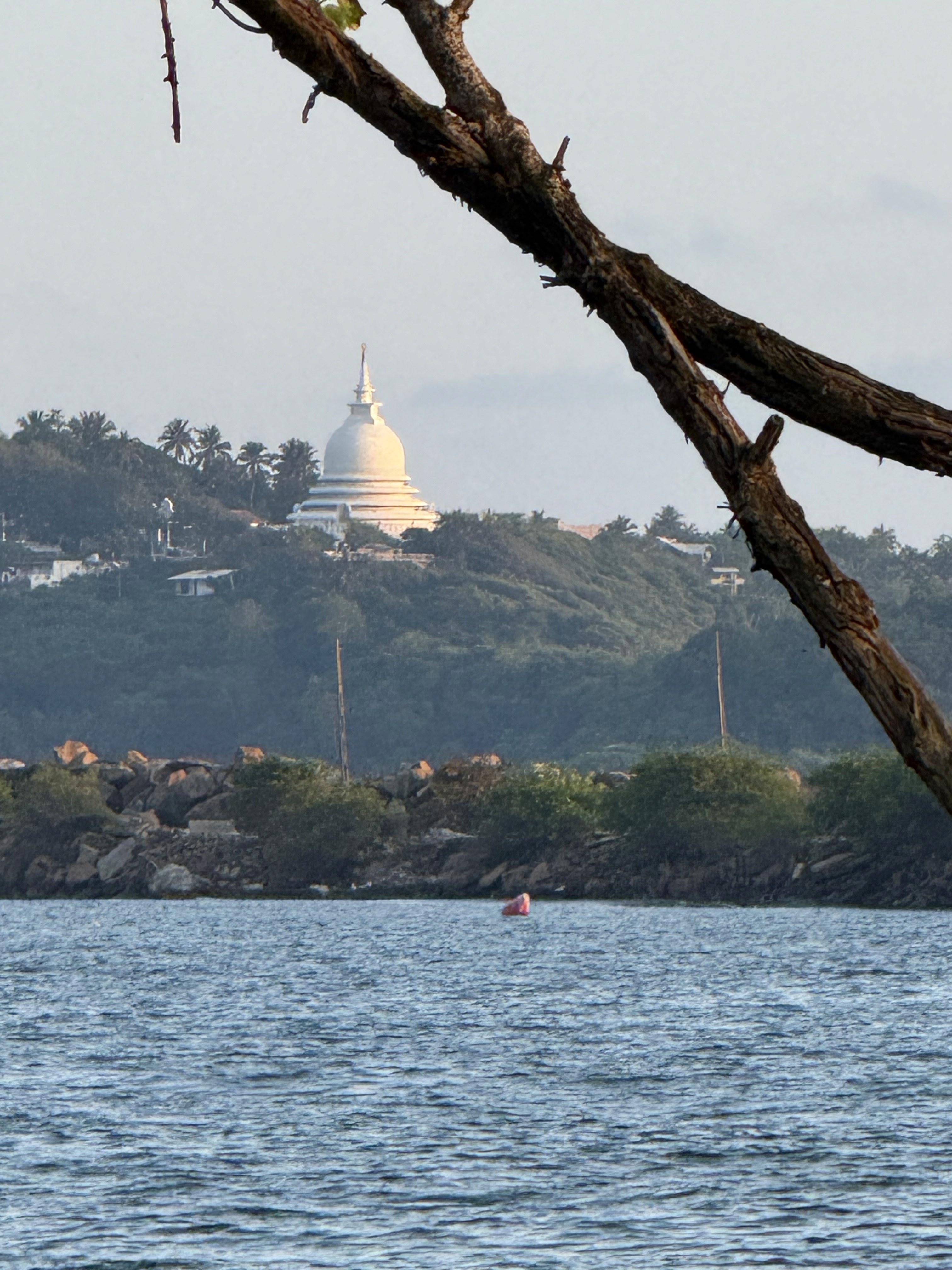 A man playing a drum in front of a group of people