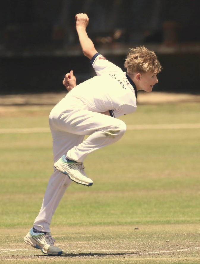 Young player bowling in cricket