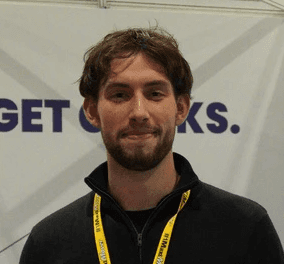 Black and white portrait of a smiling person with curly hair