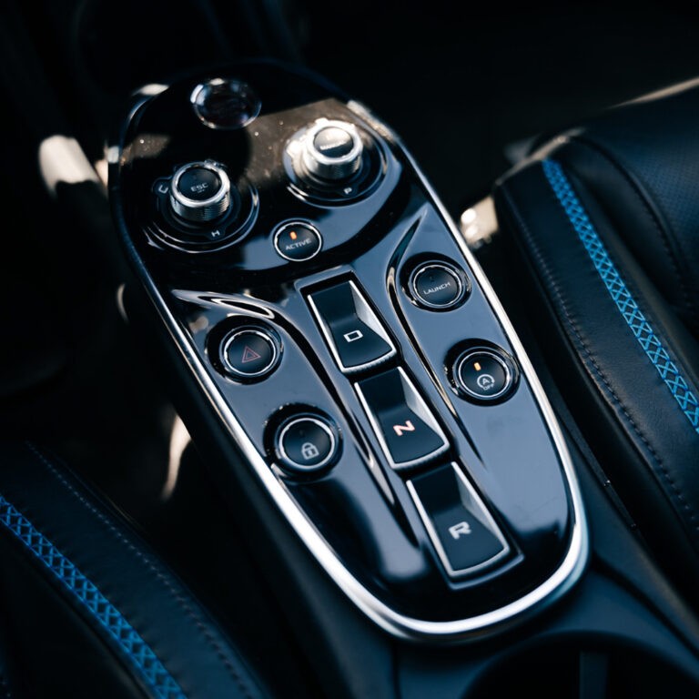 Close-up of the McLaren GT's elegant center console and driving mode selectors.