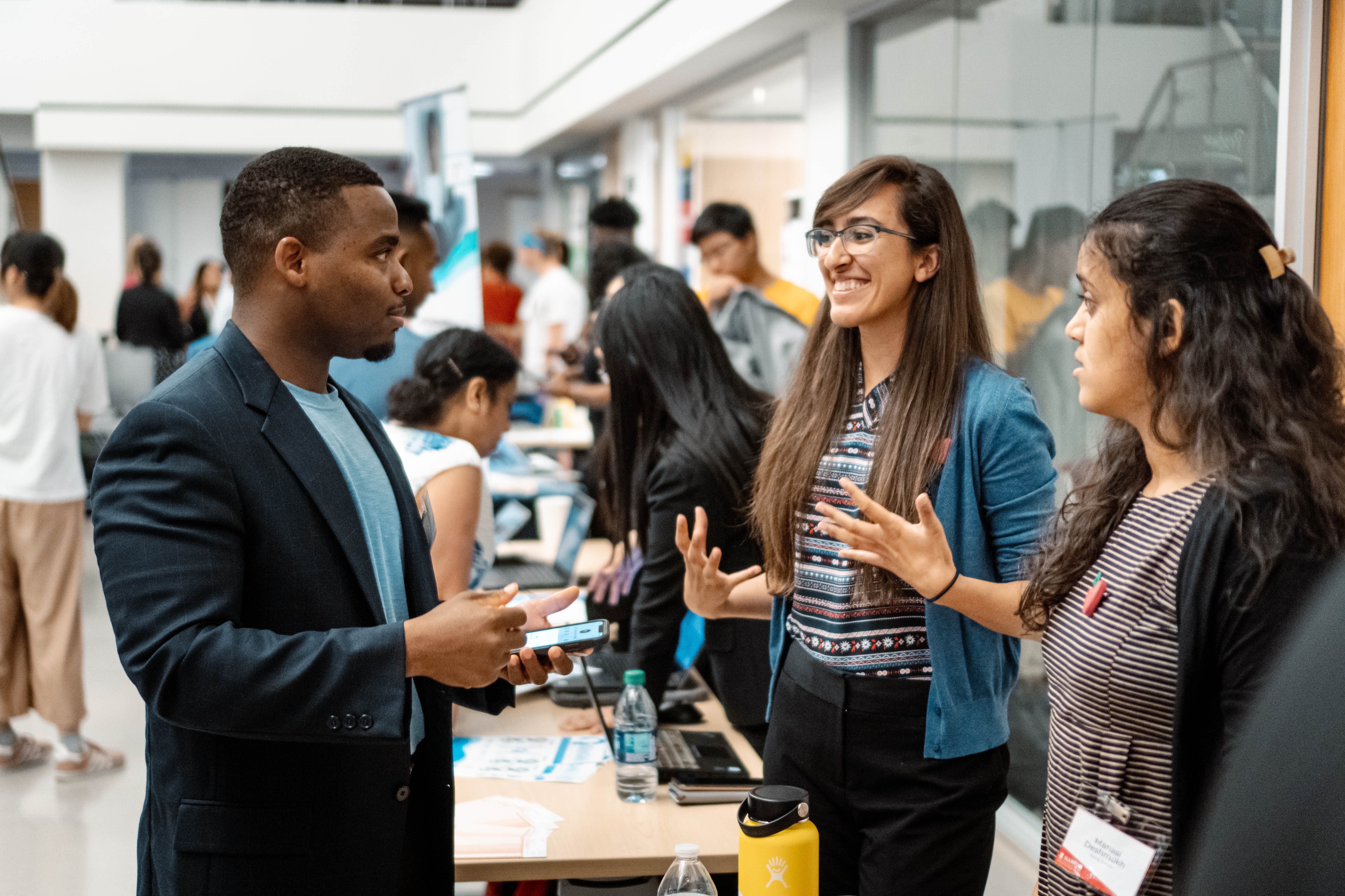 A student pitching their startup to someone visiting their startup booth.