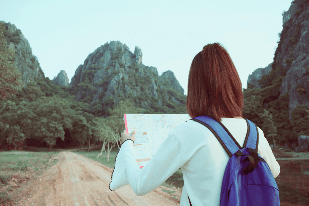 A learner wearing a backpack looks out onto a large, immersive digital landscape, representing the engaging and effective learning experiences created through instructional design.