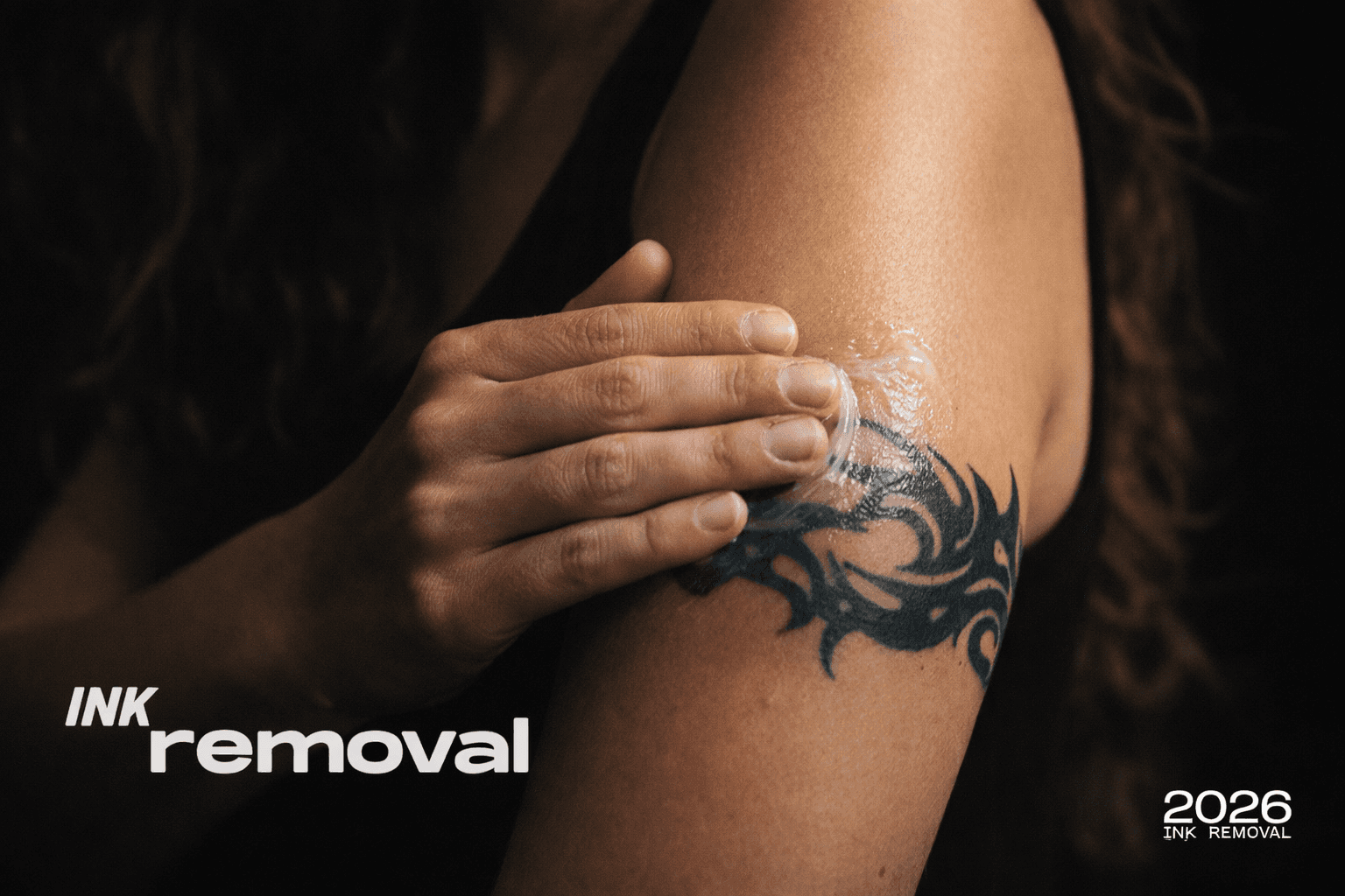 woman applying healing ointment to arm tattoo as part of tattoo removal aftercare