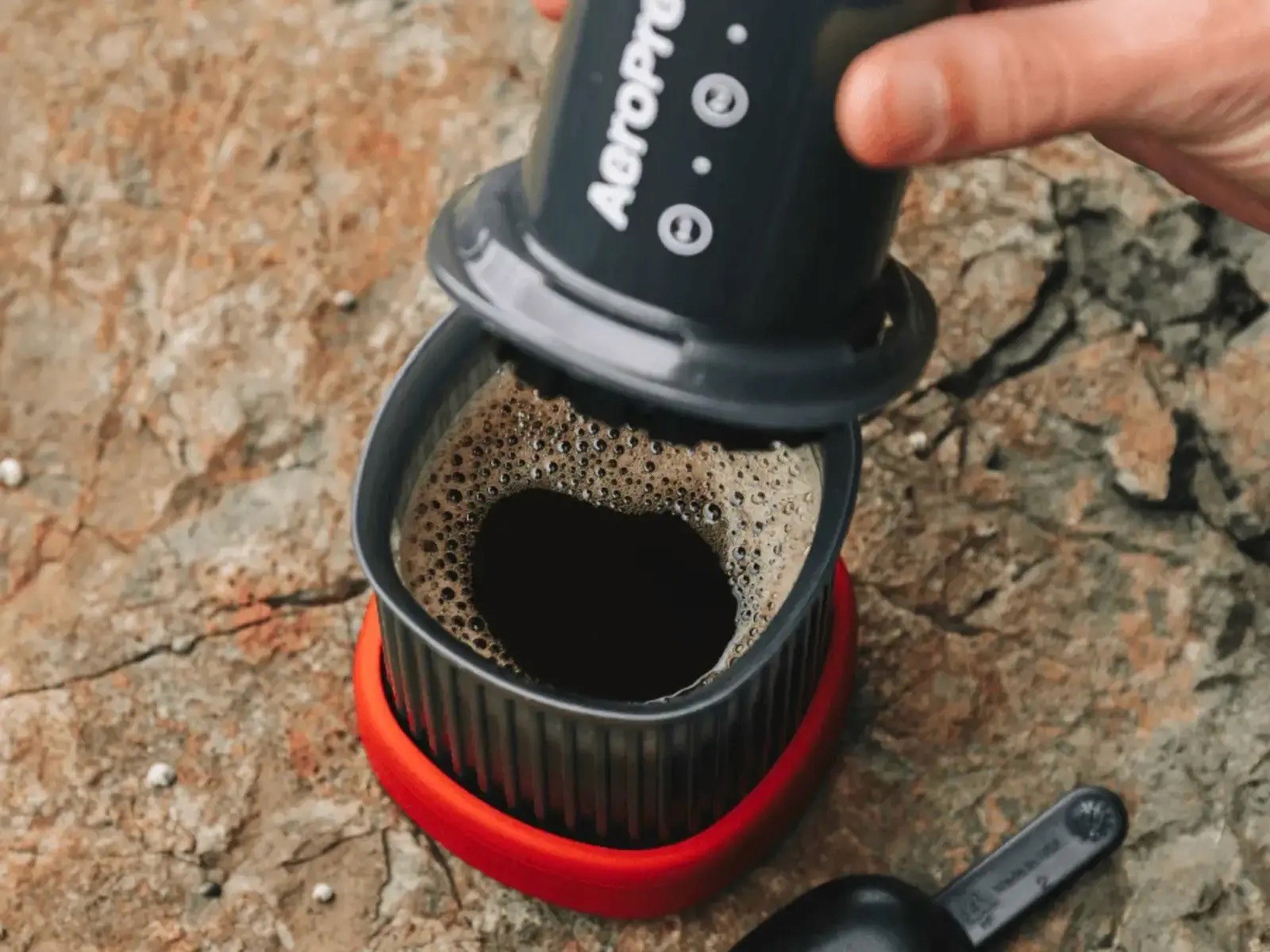 Close-up of freshly pressed coffee made outdoors using the AeroPress — Go
