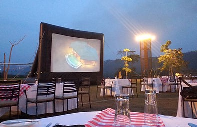 An outdoor cinema screen at a gathering