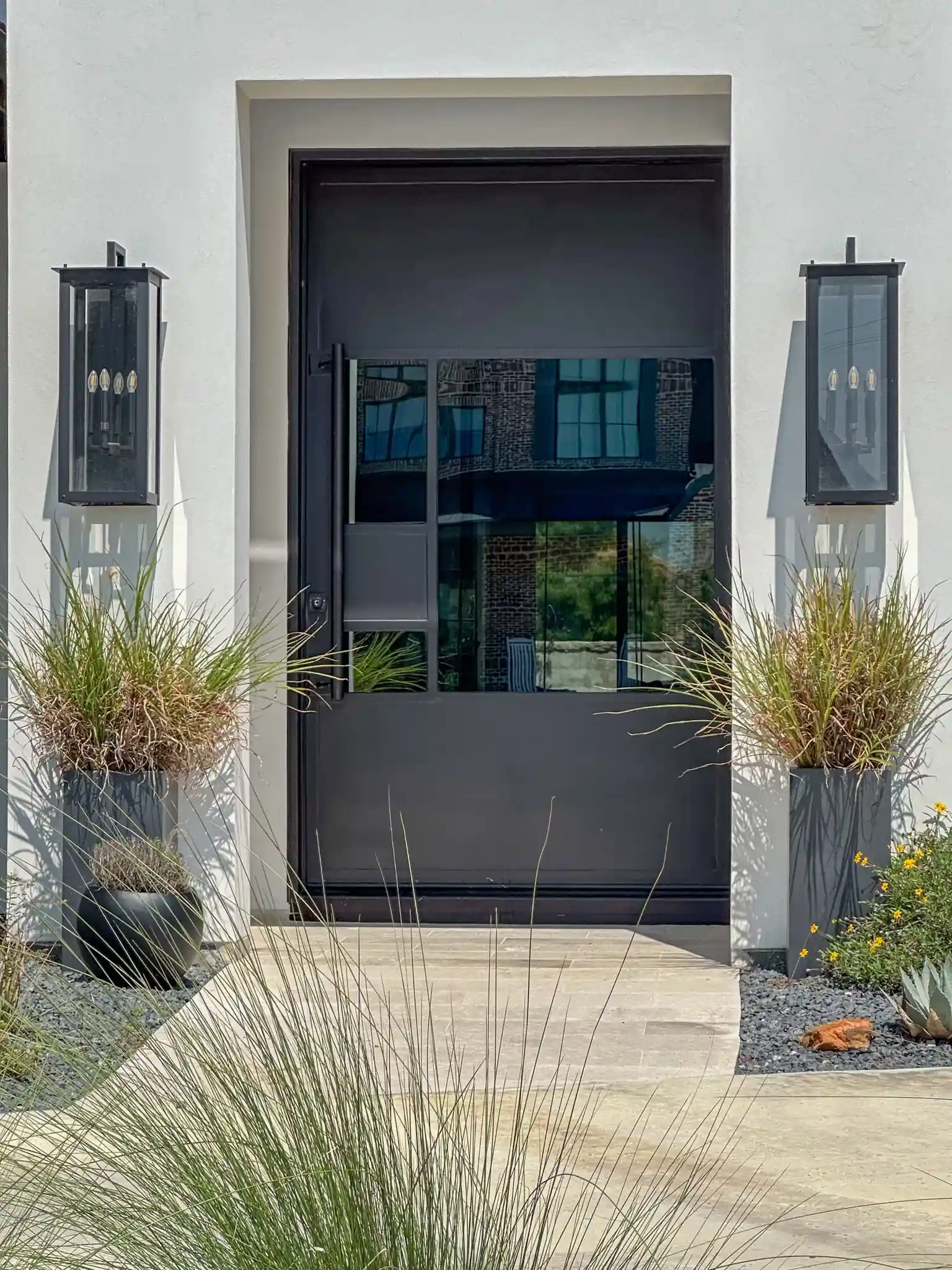 Contemporary pivot door installed on a DFW home by M2 Metals Iron DOors