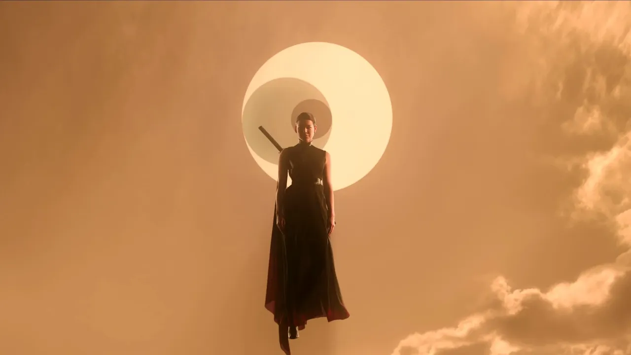 A silhouetted figure stands poised against a dramatic, sunlit sky with glowing planets in the behind in the distance, holding a sword reminiscent of samurai style, evoking themes of strength and mystery.