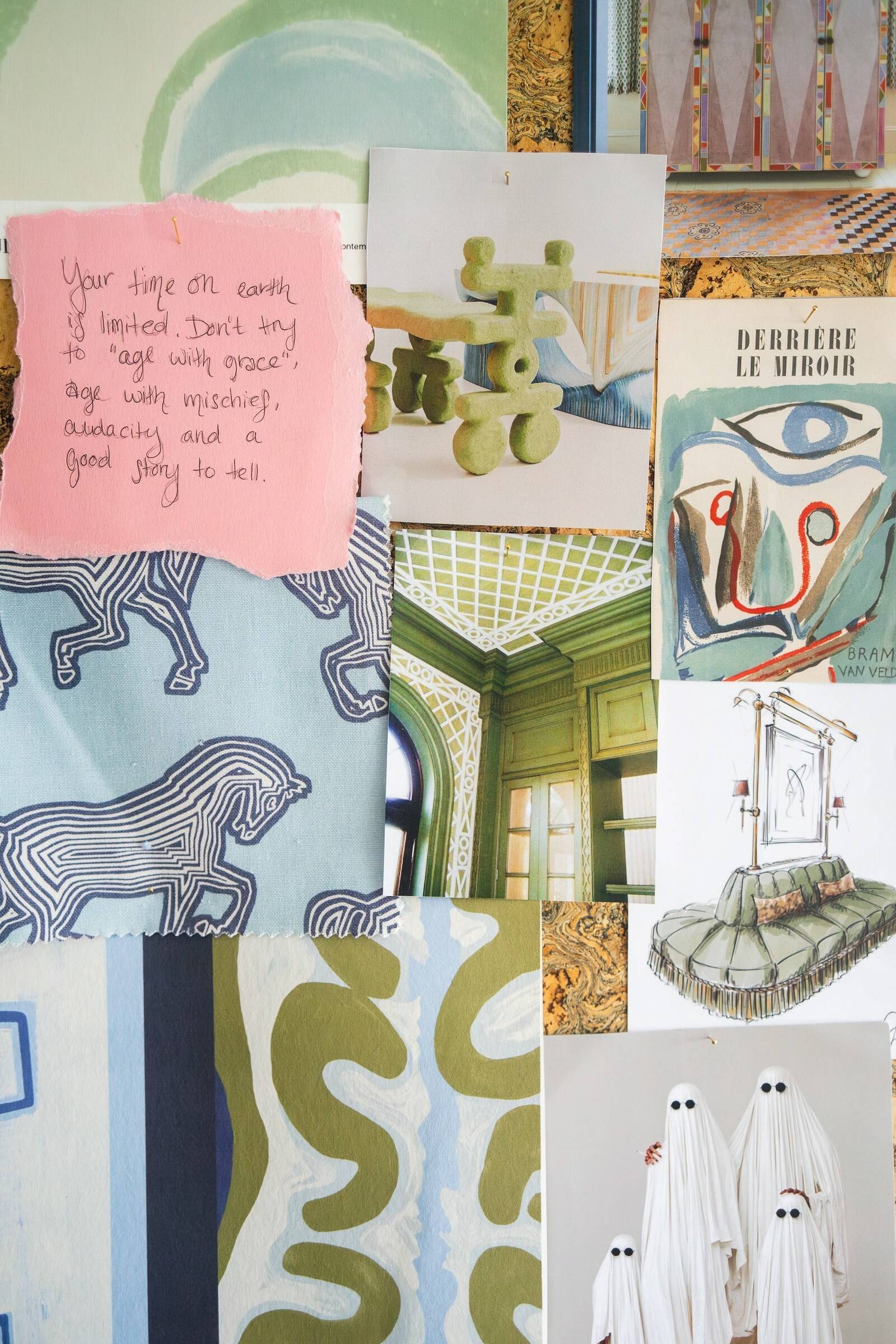 Close-up of a mood board featuring fabric samples, sketches, and an inspirational note.