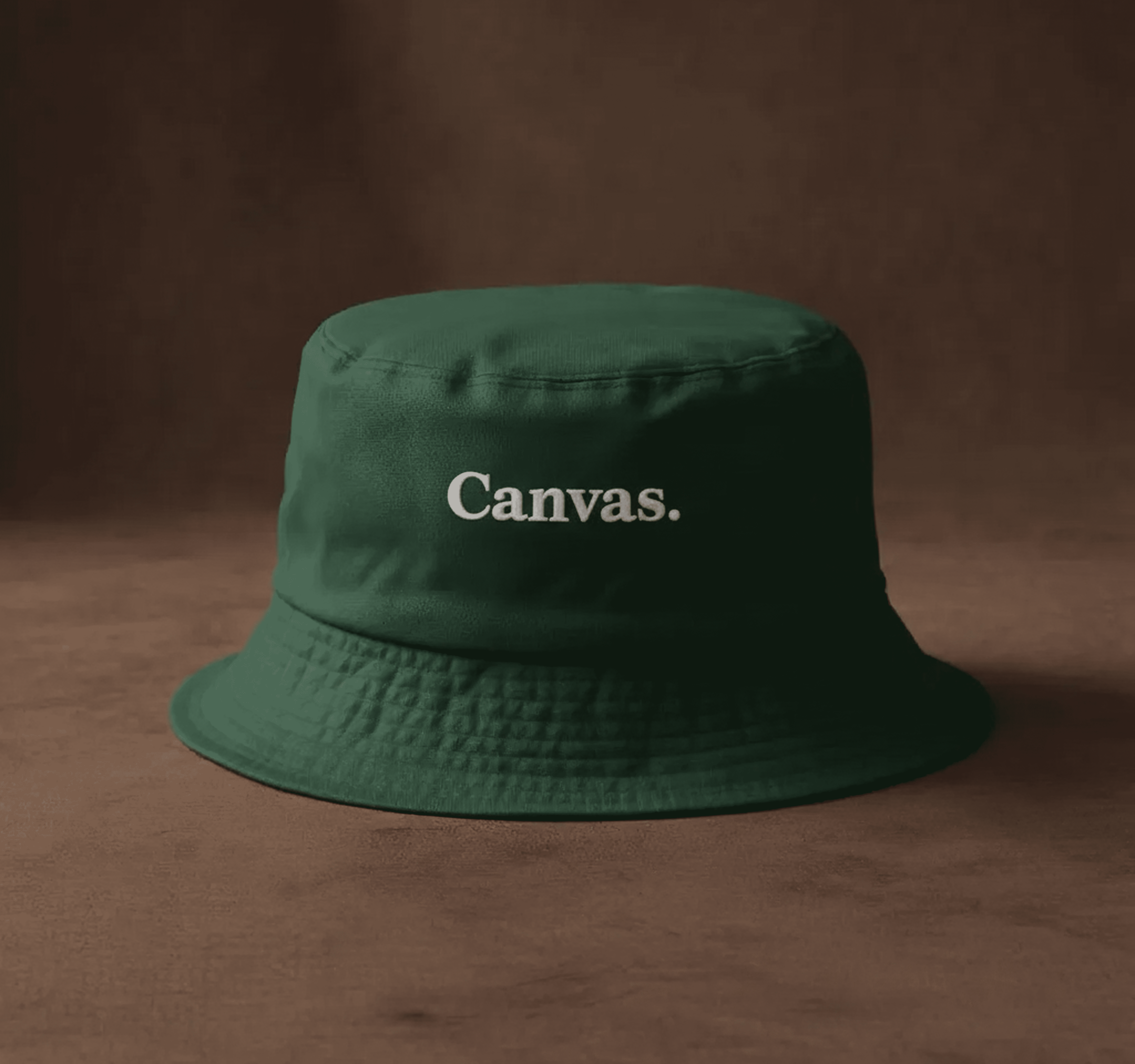 Dark green bucket hat with white 'Canvas.' text