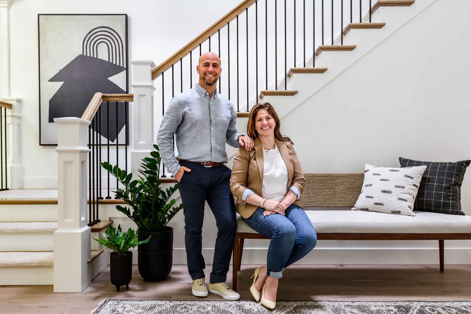 John and Sherri Monte pose in a remodeled clean bright and airy kitchen in Beacon Hill, WA.  Elegant simplicity is a full service interior design firm.