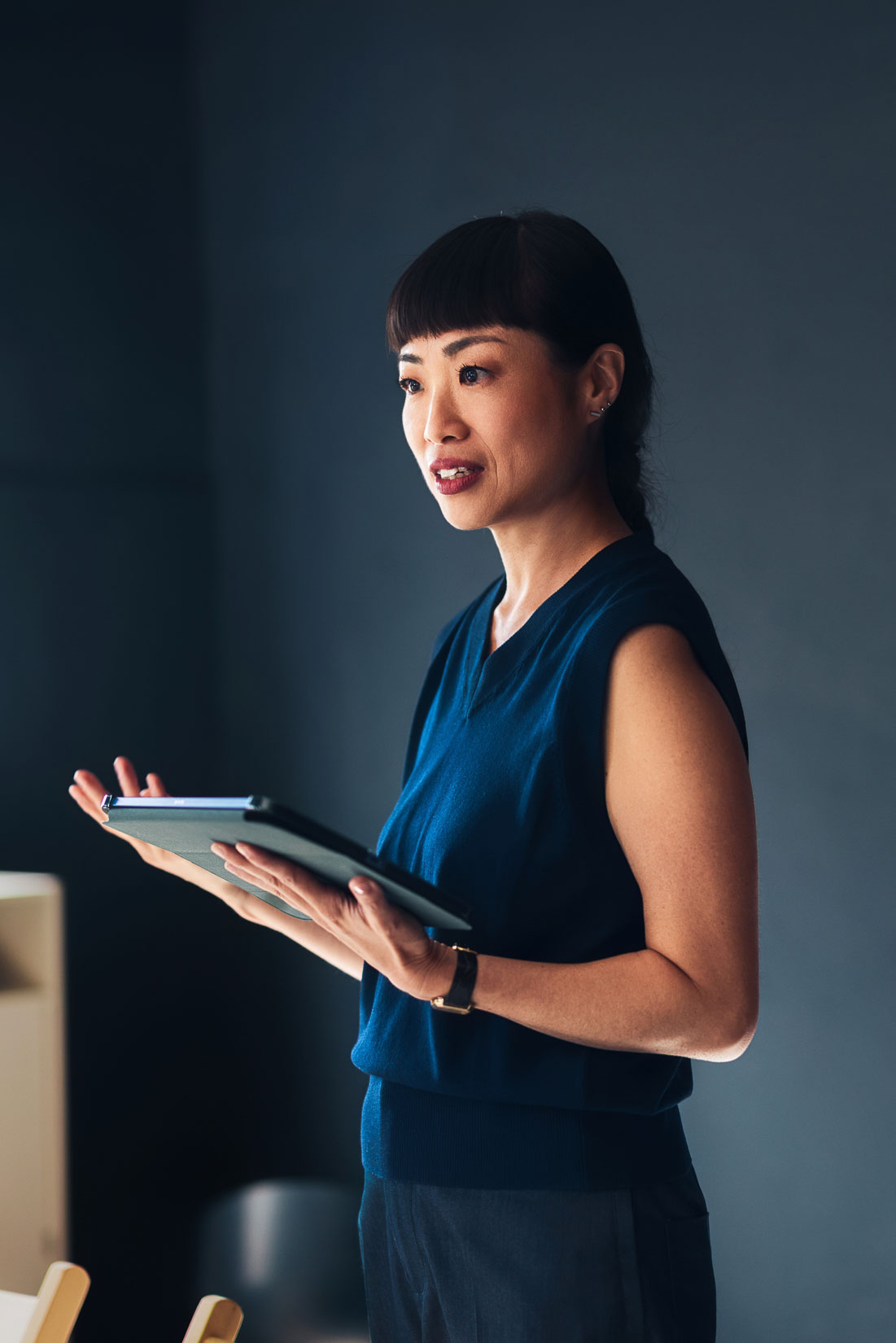 E-3 visa lawyer presenting with tablet in office