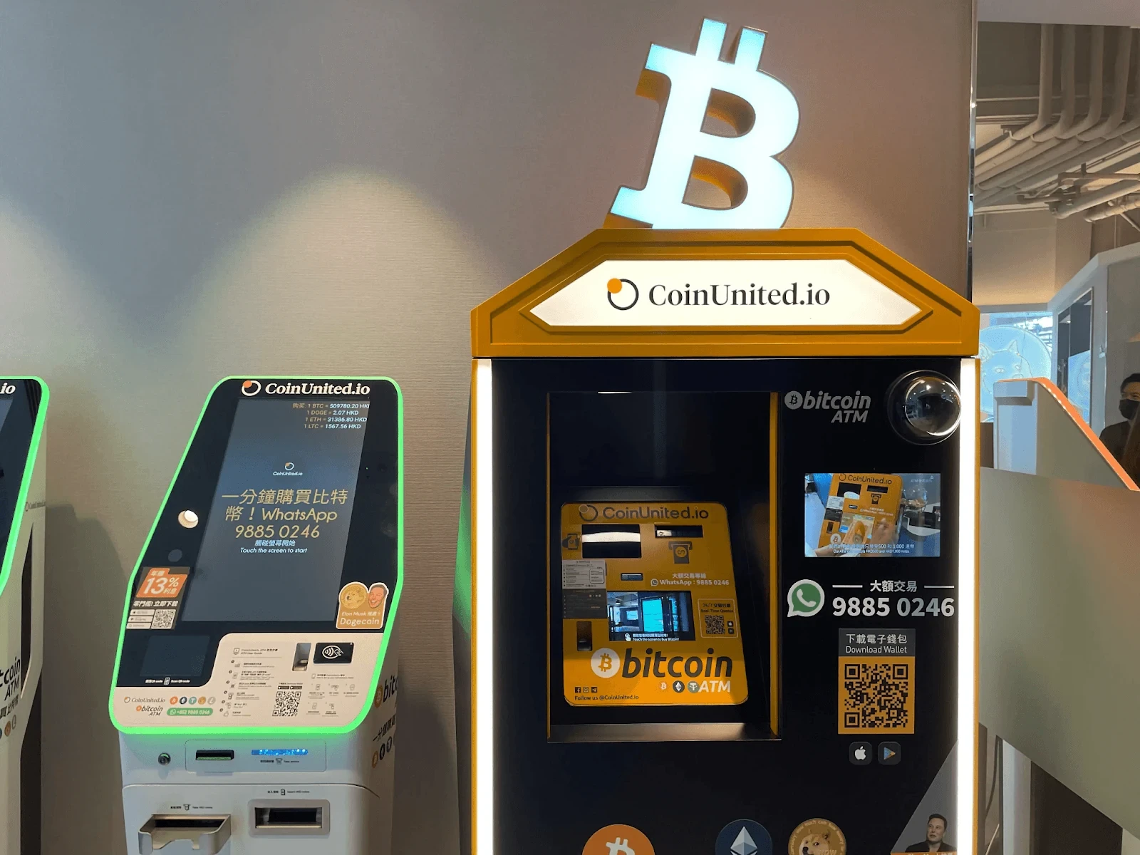 CoinUnited.io Bitcoin ATM kiosks with illuminated Bitcoin logo and WhatsApp contact details
