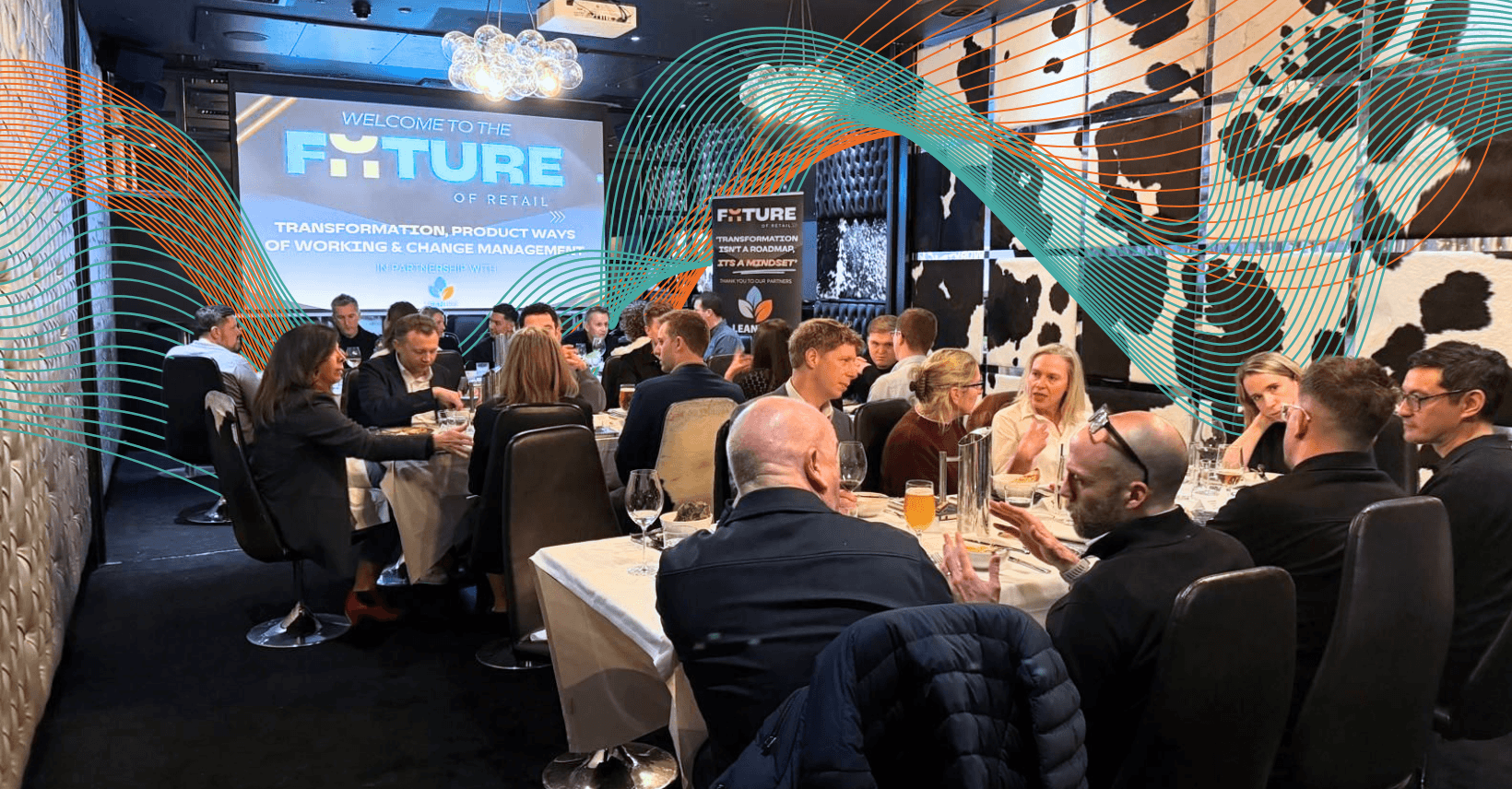 Room of senior retail leaders eating dinner with blue and orange technology visuals woven throughout