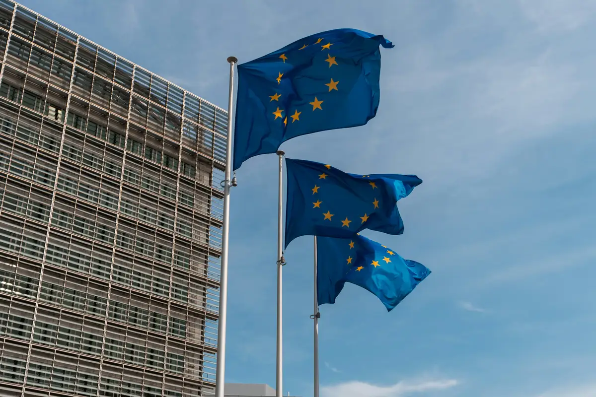 EU flags waving in front of a modern building