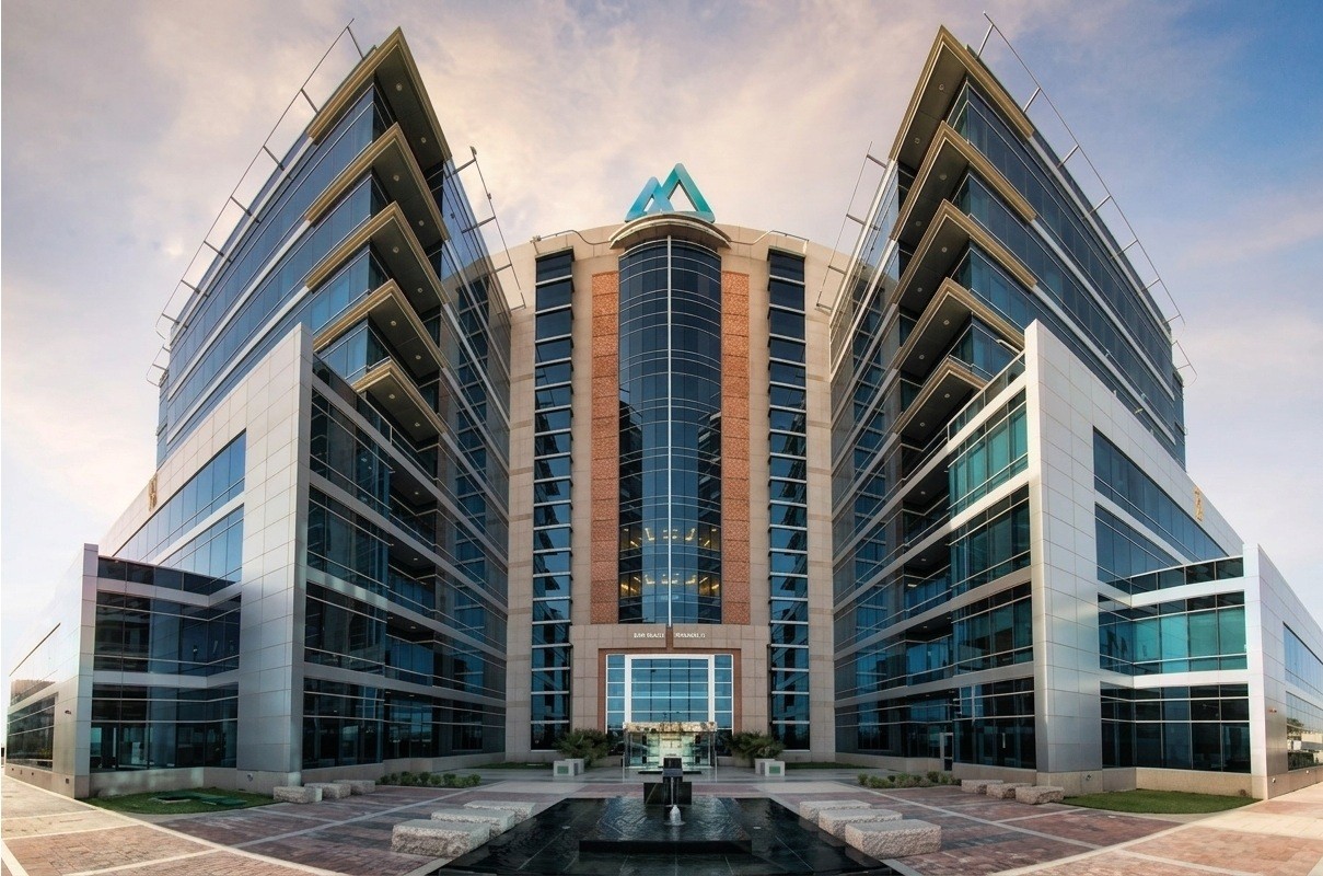 Aerial night view of The Gate building and skyscrapers in the Dubai International Financial Centre (DIFC) business district. 
