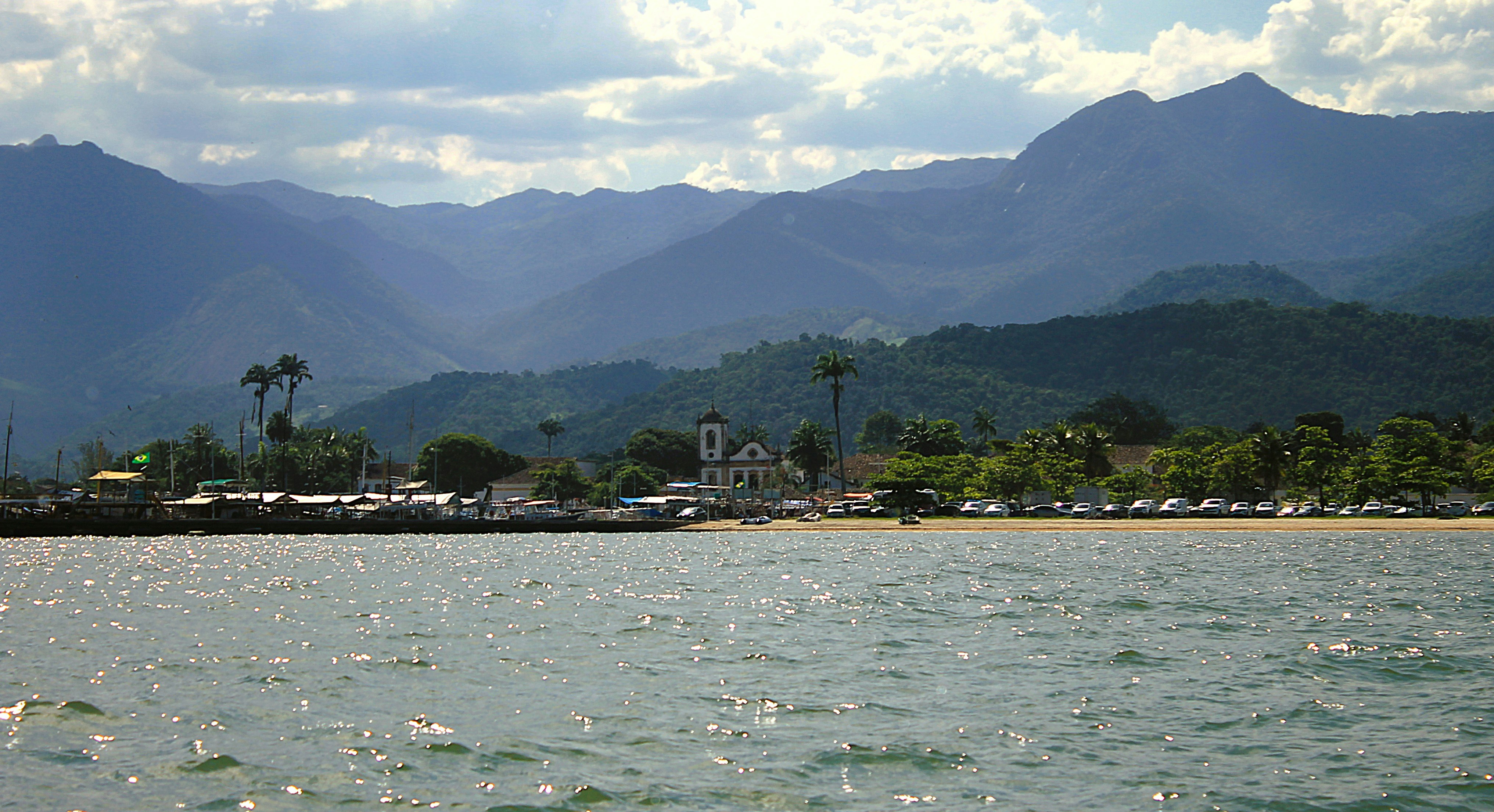 A body of water with mountains in the background