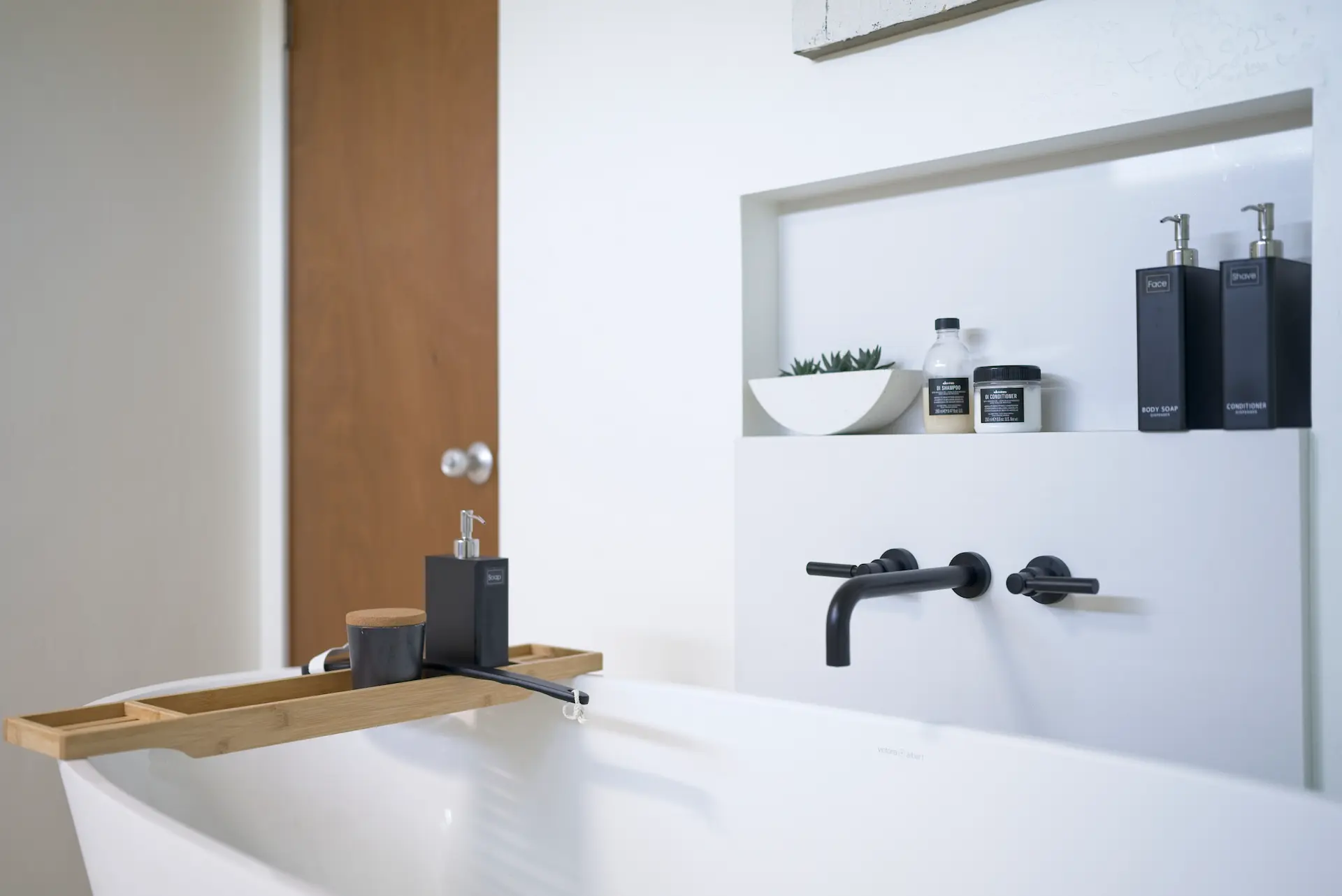 Close-up view of the free-standing tub from angle one, emphasizing its shape and placement in the primary bathroom of the Fairhaven Eichler Tract remodel. Photo by Todd Huge.