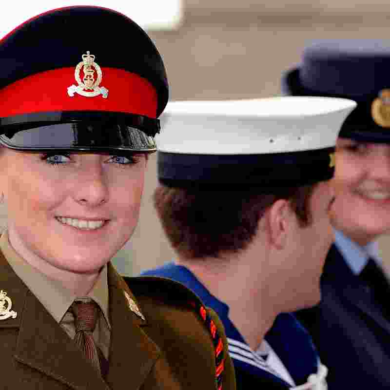 Photo of a smiling armed force memeber looking at the camera wearing formal uniform