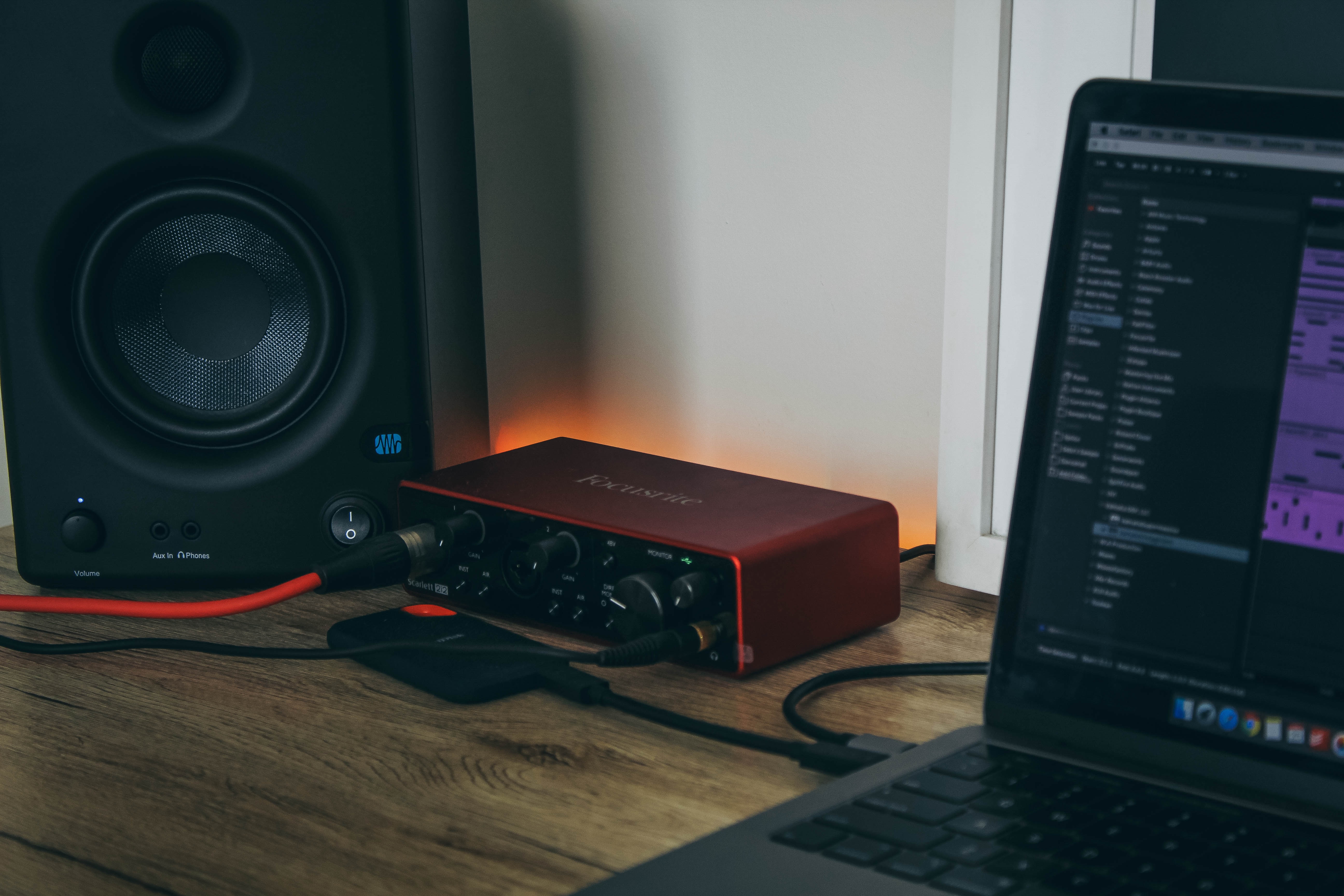 man editing music with high bass speakers - wavtool ai vs musicfy