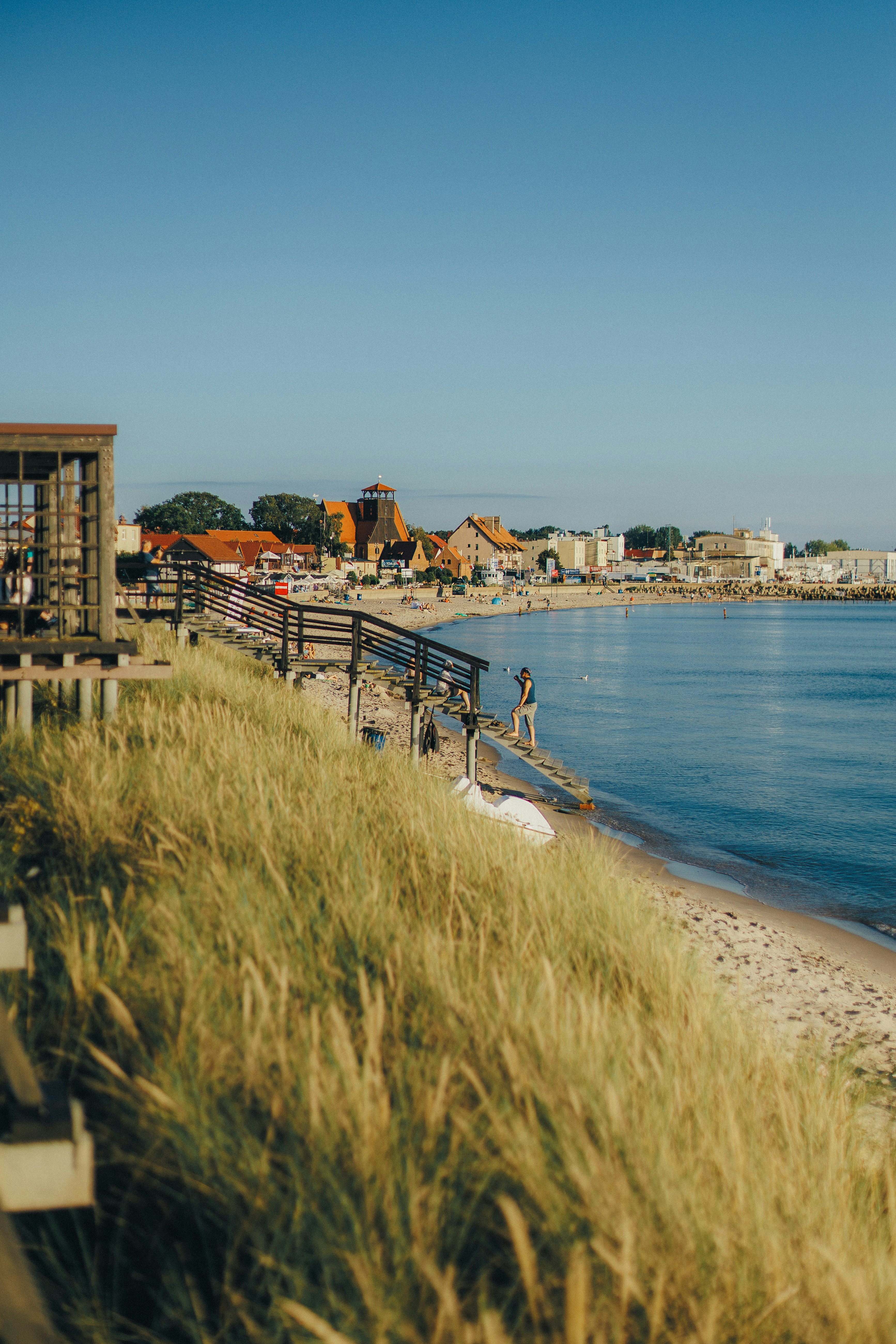 gray concrete dock bridge near seashore