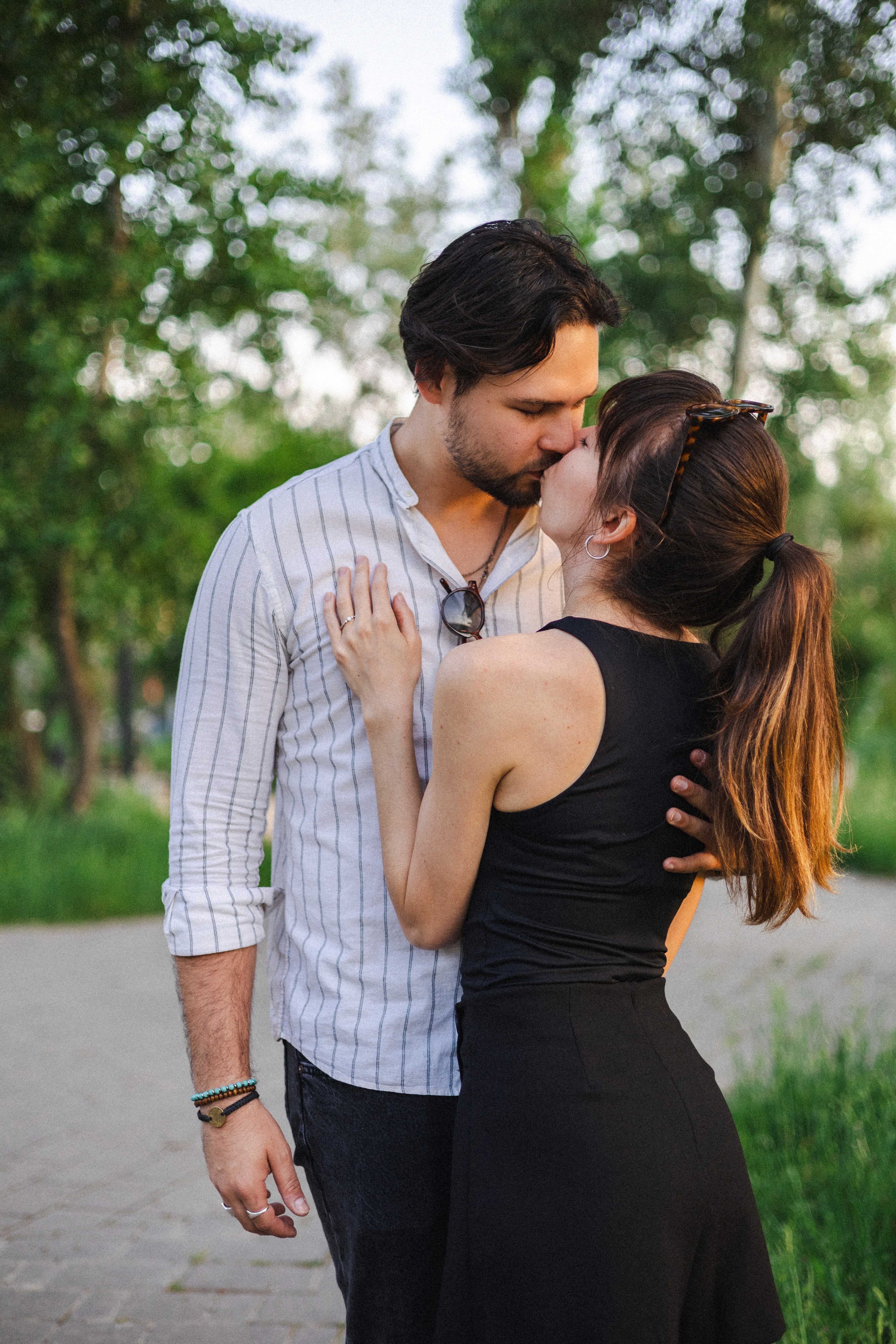 A woman in motion during a yoga session in a light-filled modern room with large windows, wood floors