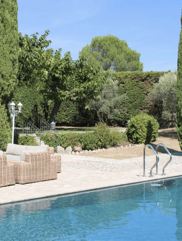 brown wooden house surrounded by green trees during daytime