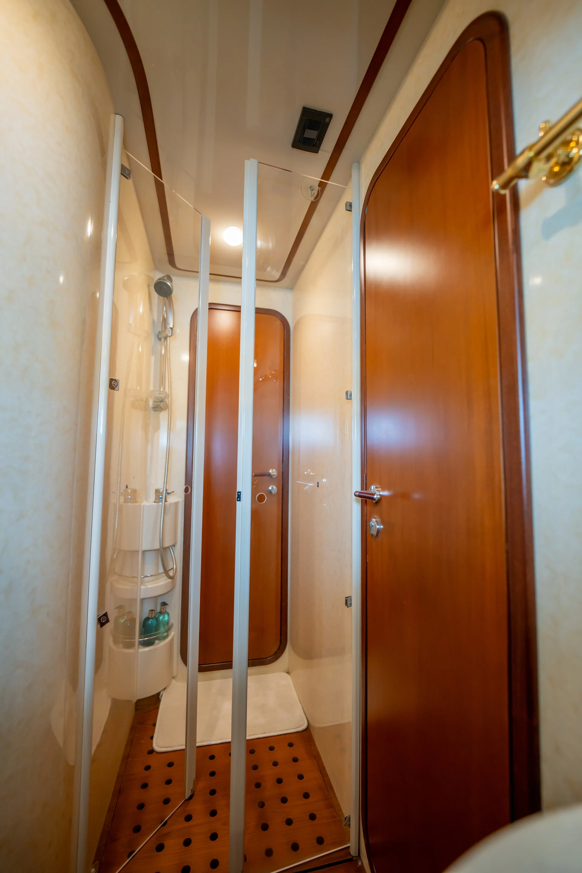 White Rock 36 speedboat with captain at helm cruising calm blue waters near Paros coastline with hills in background.