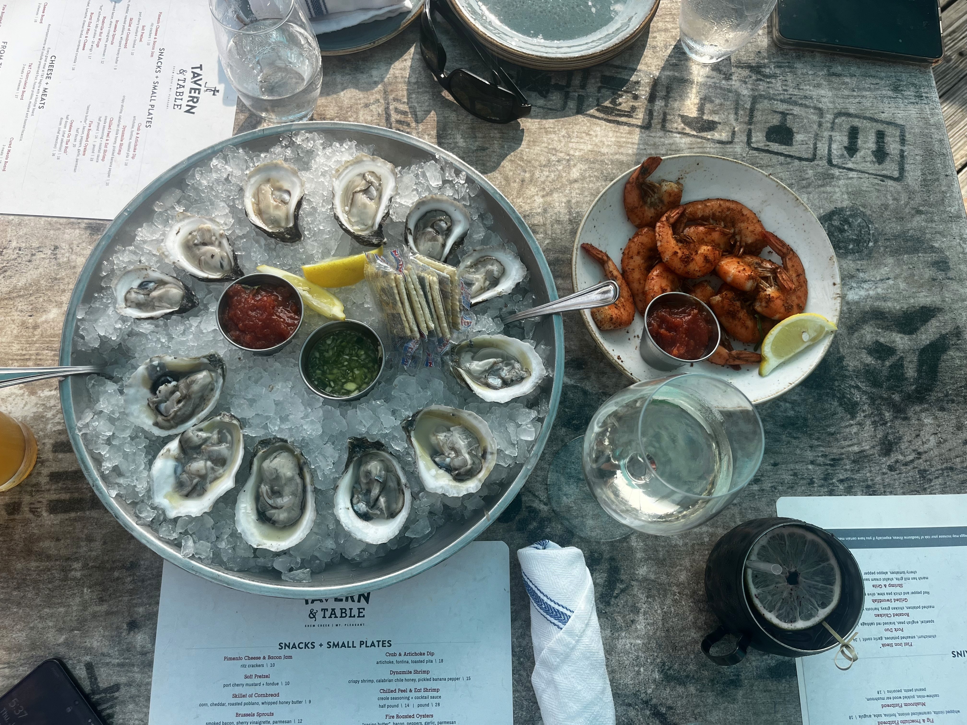 Tavern & Table’s seafood duo: a dozen oysters on the half shell with lemon wedges and mignonette (left), and chilled peel-and-eat shrimp seasoned with creole spice and served with cocktail sauce (right).