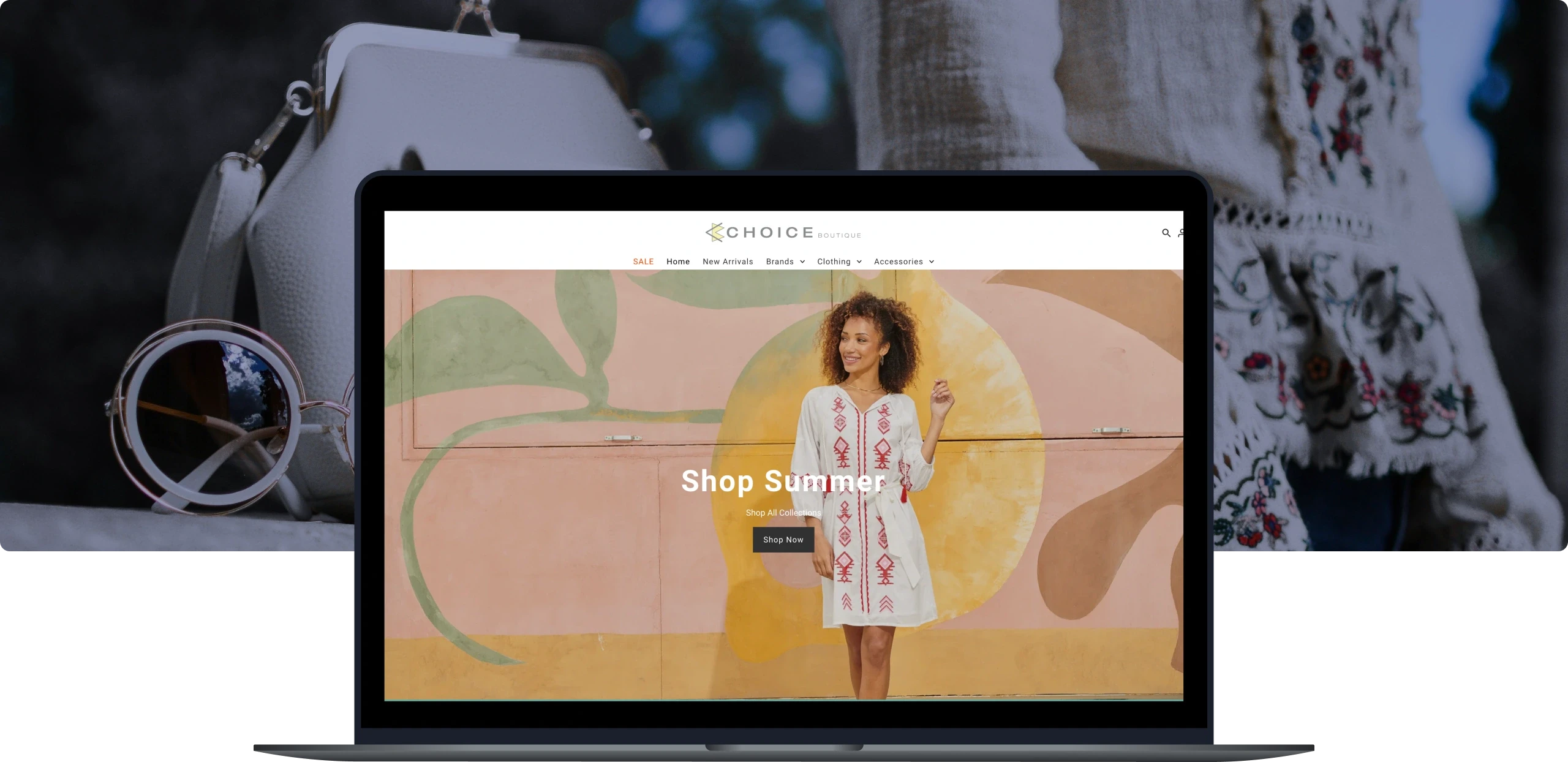 Laptop displaying Choice Boutique's website with a 'Shop Summer' banner featuring a smiling woman in a white dress with red embroidery, standing in front of a colorful, abstract mural. The scene is accompanied by sunglasses and a handbag in the background, evoking a stylish and trendy fashion theme.