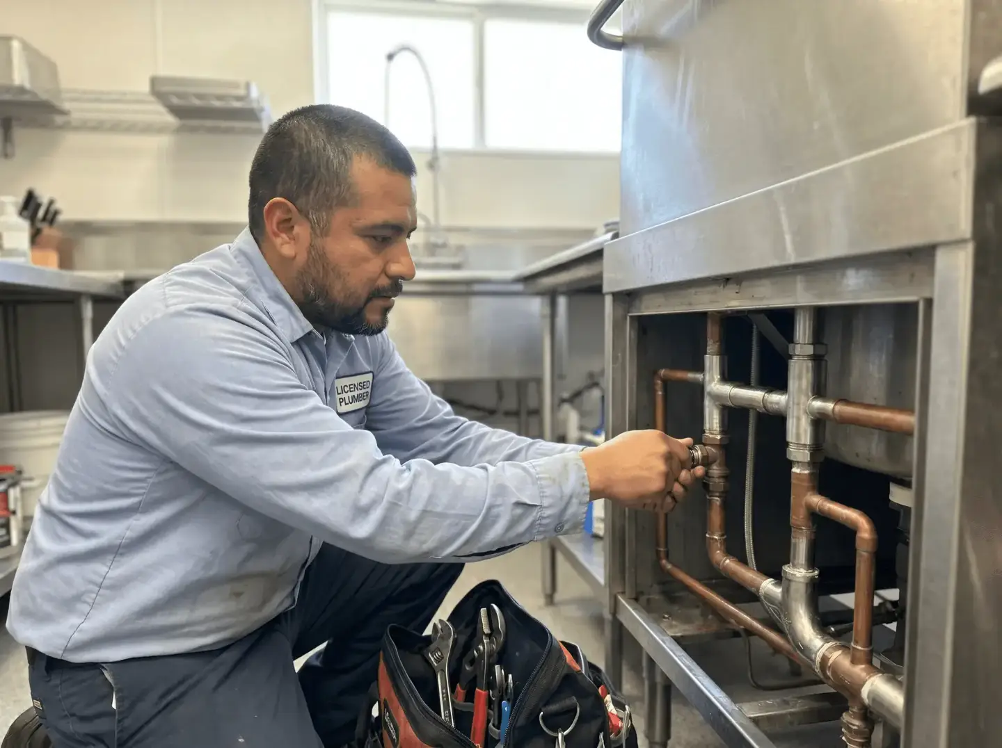 Plumber performing commercial plumbing work at a Philadelphia business