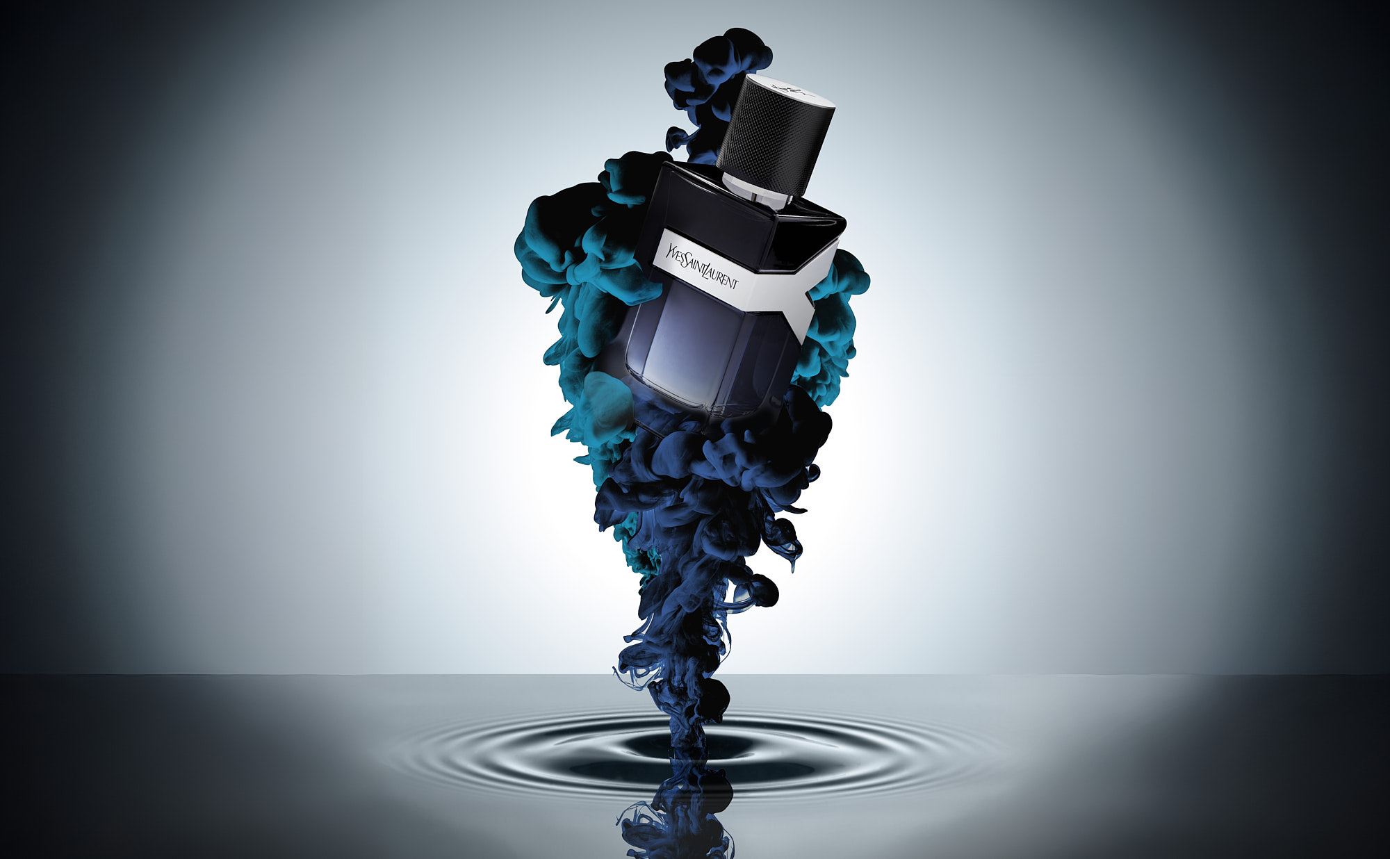 A mens dark perfume bottle in a ploom of ink against a softly lit, gradient background.