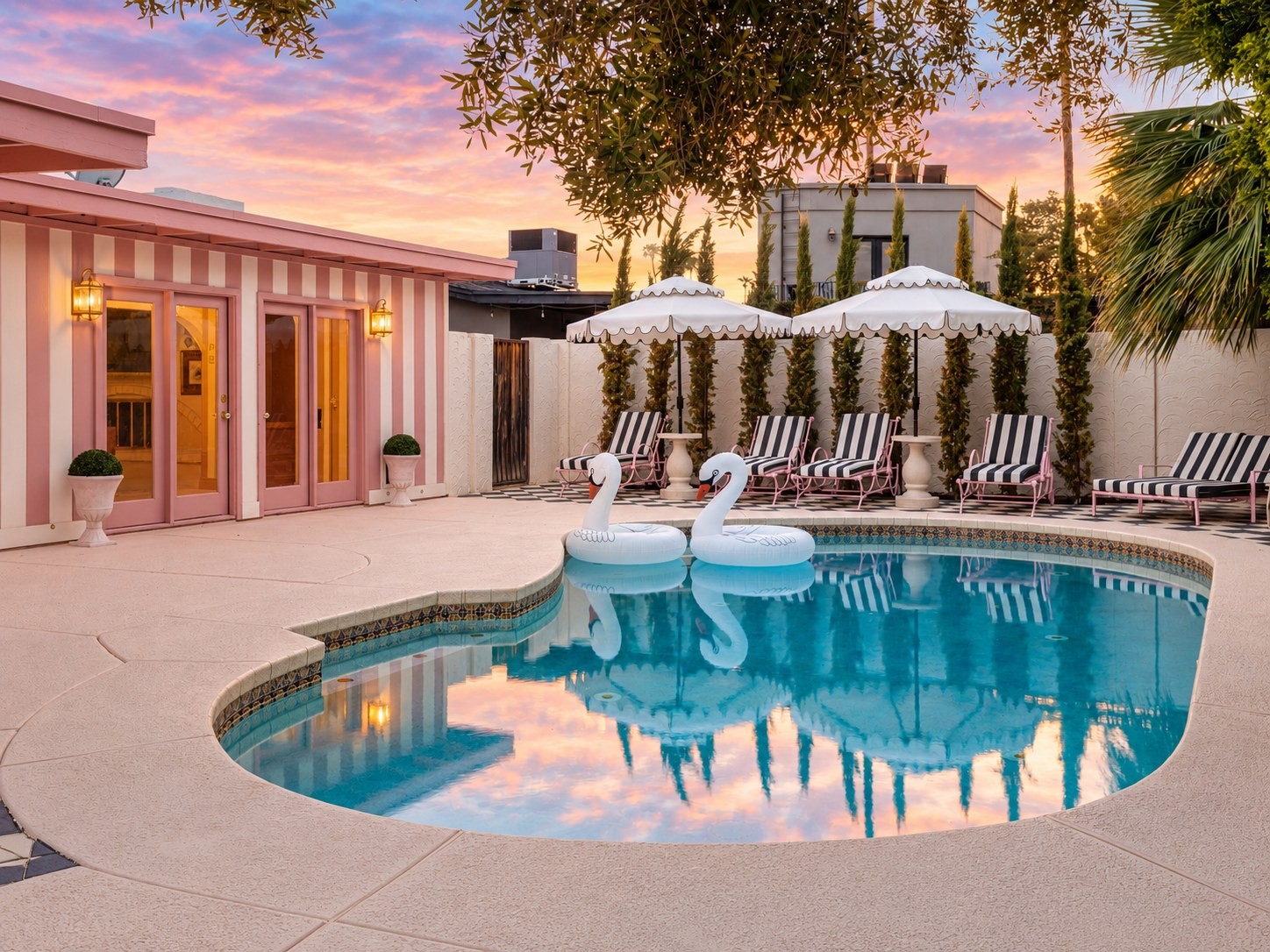 Sparkling pool and checkerboard courtyard at dusk