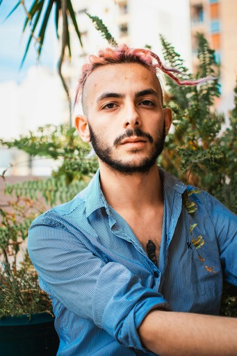 a man with a goatee and a blue shirt