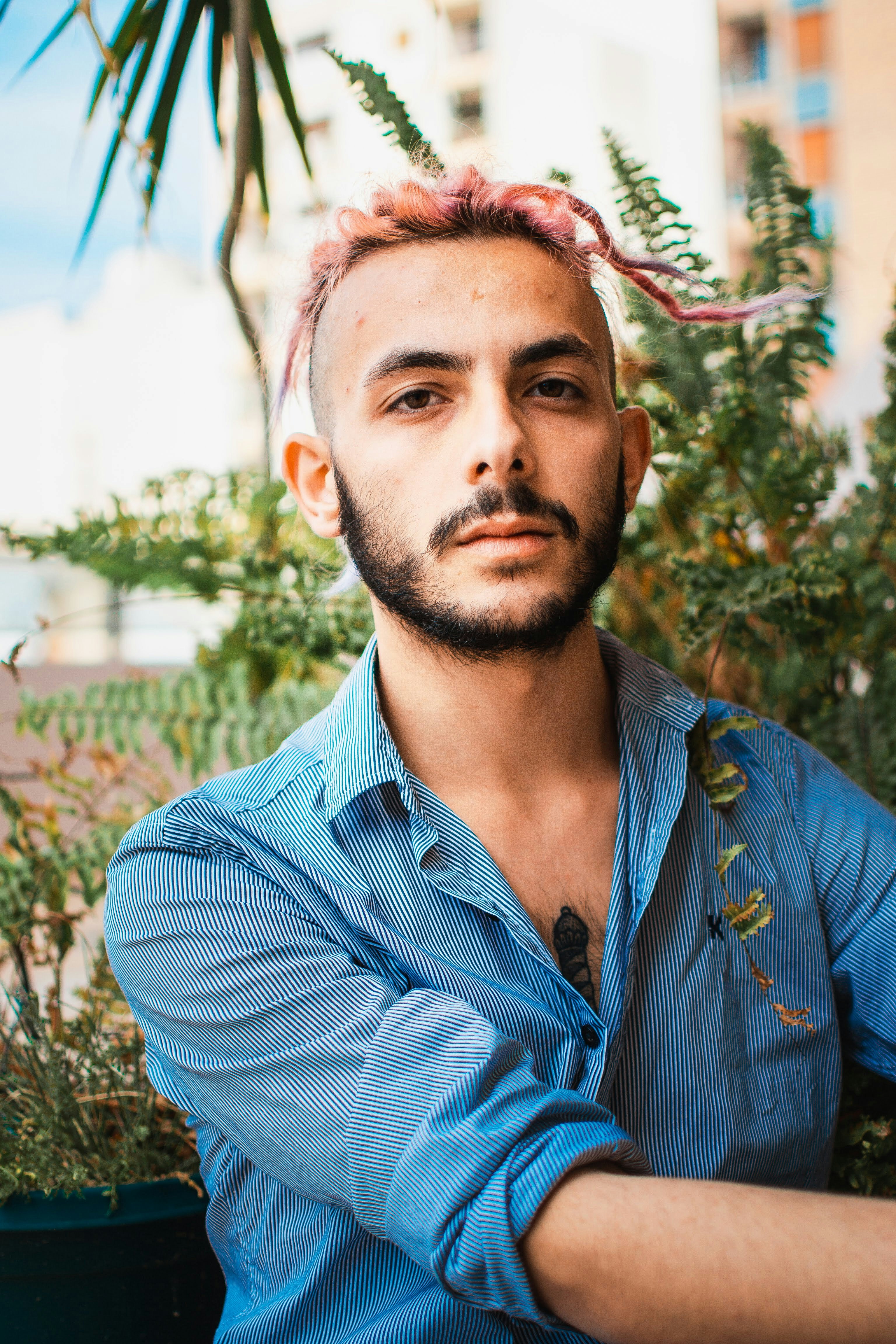 a man with a goatee and a blue shirt