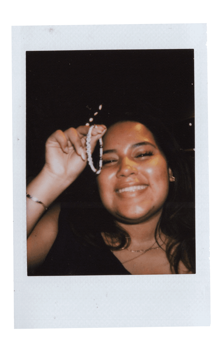 Fujifilm photo of a girl holding a friendship bracelet