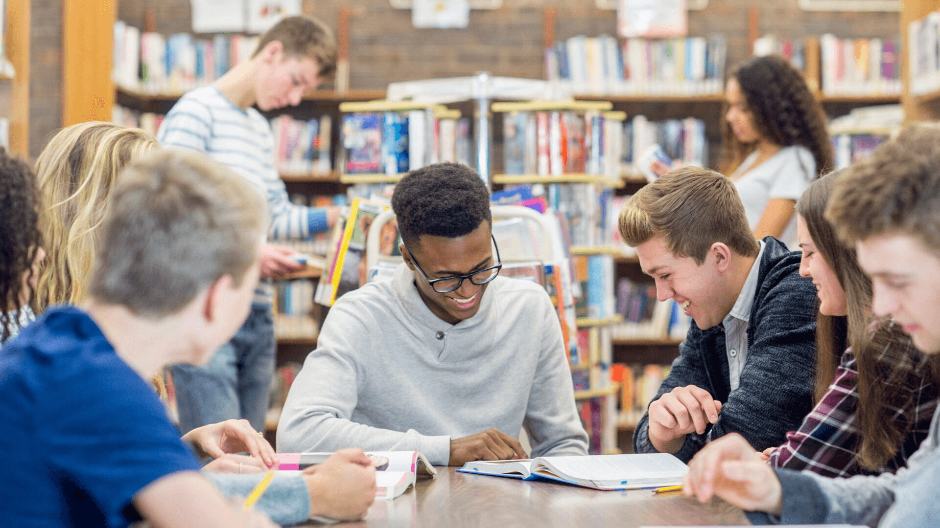 High school student reviewing summer program costs and college application materials at a desk