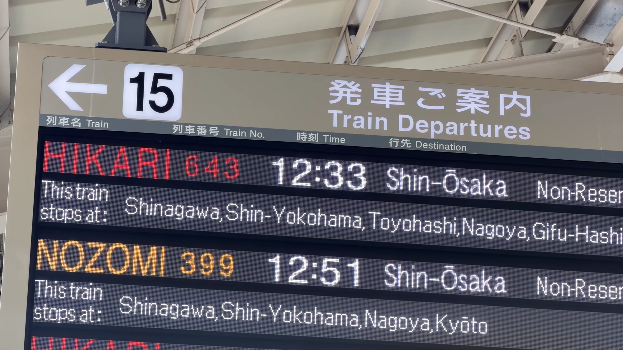 An English-language train departures board listing Hikari and Nozomi services to Shin-Osaka.