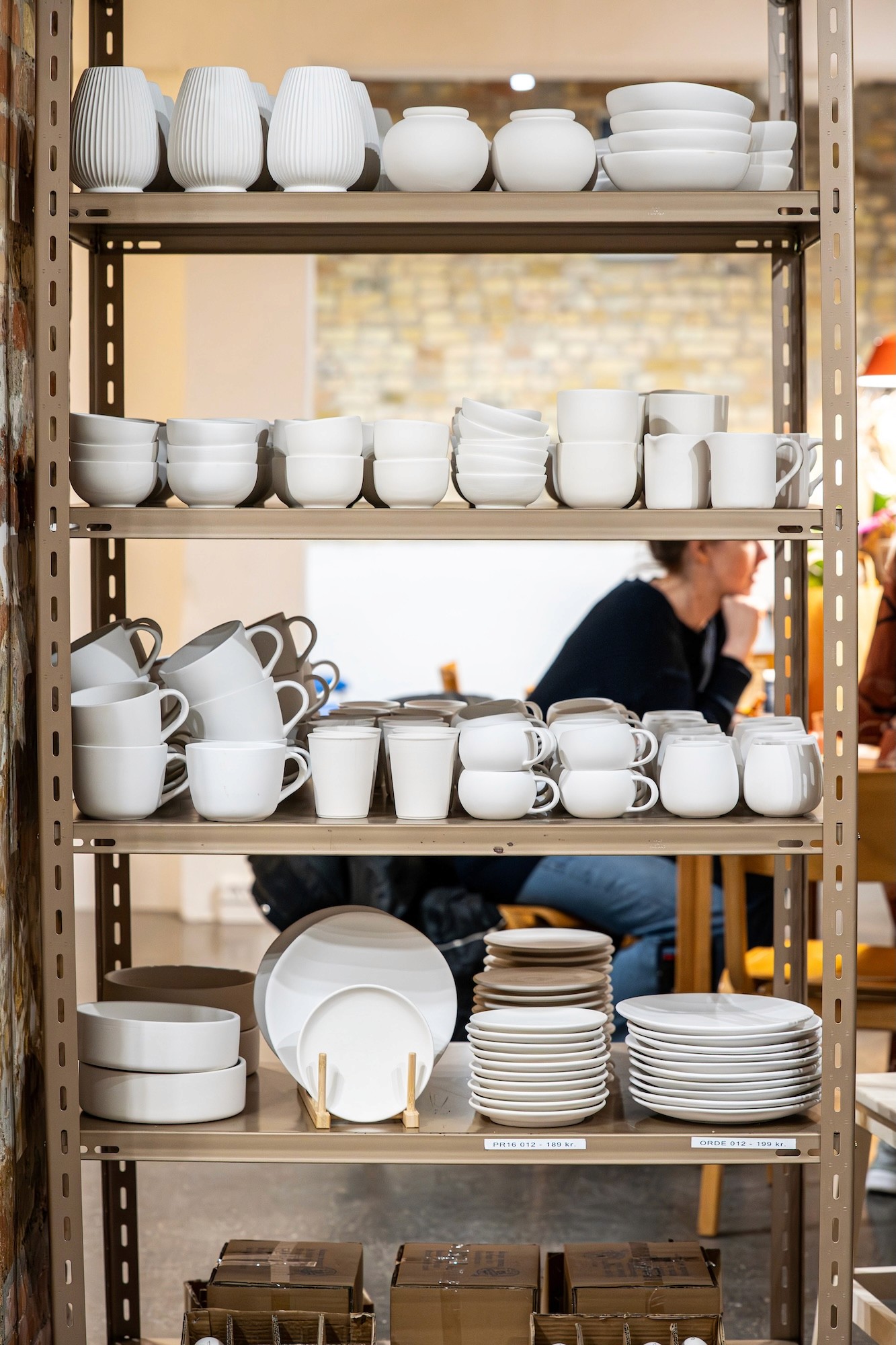 a shelf full of pottery items for creative painting activities