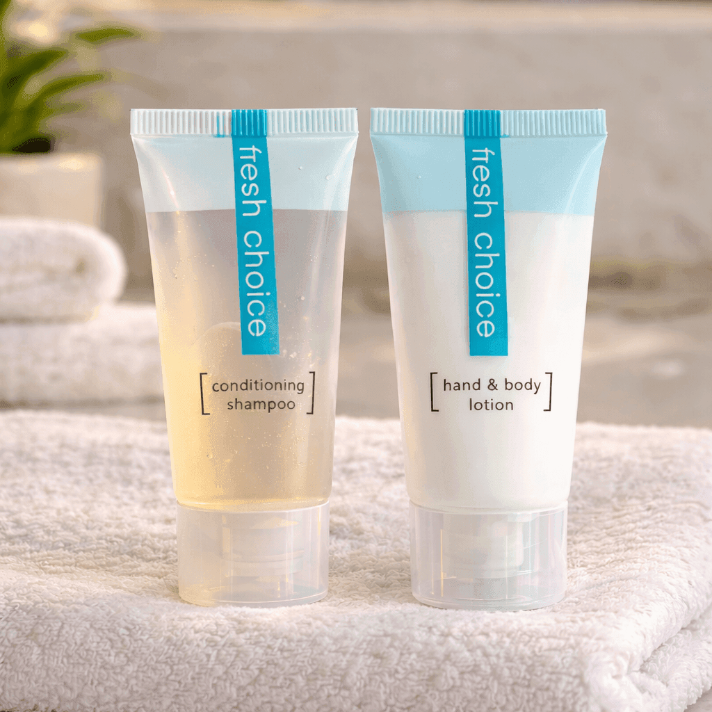 Fresh Choice conditioning shampoo and hand & body lotion by Transmacro Amenities displayed on towel in a hotel bathroom setting