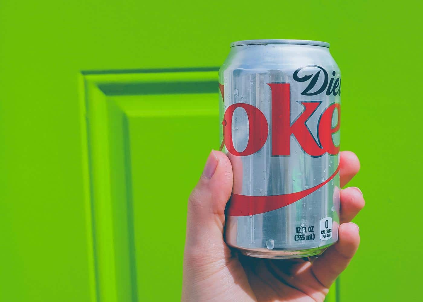 Is diet soda bad for you? Diet coke can against a green background