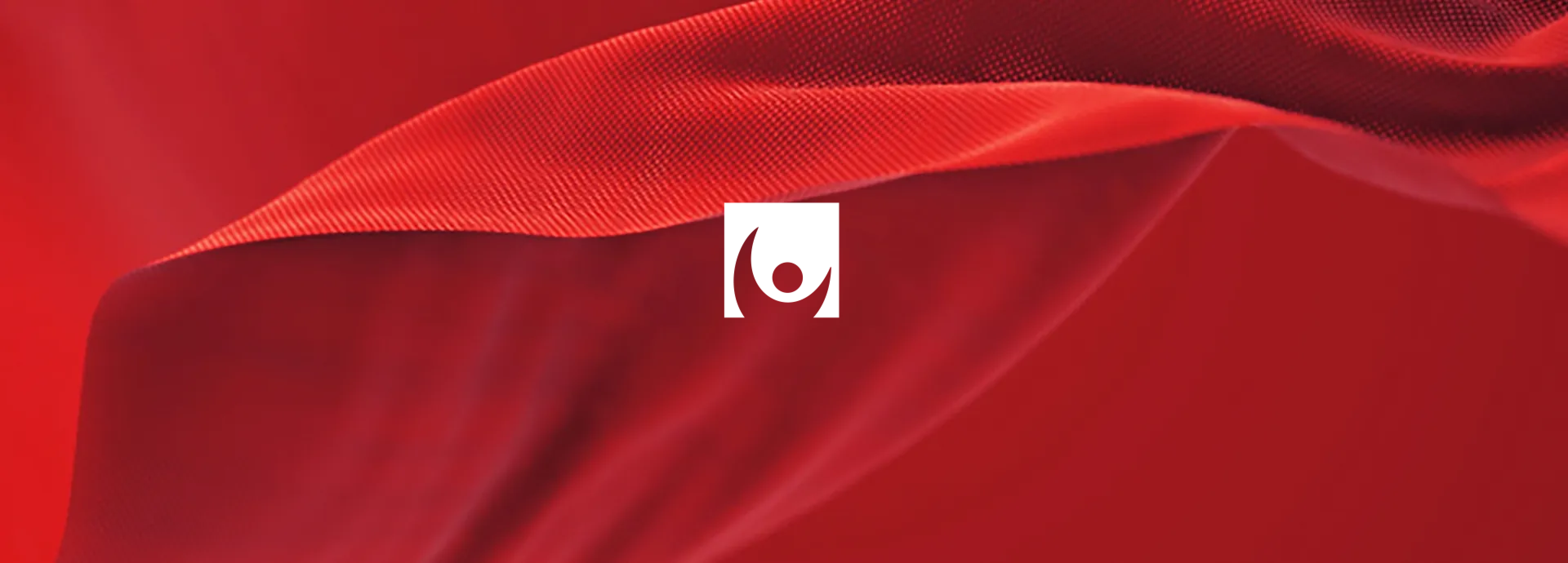 A white minimalist eye-shaped logo centered over a flowing, textured red fabric background.
