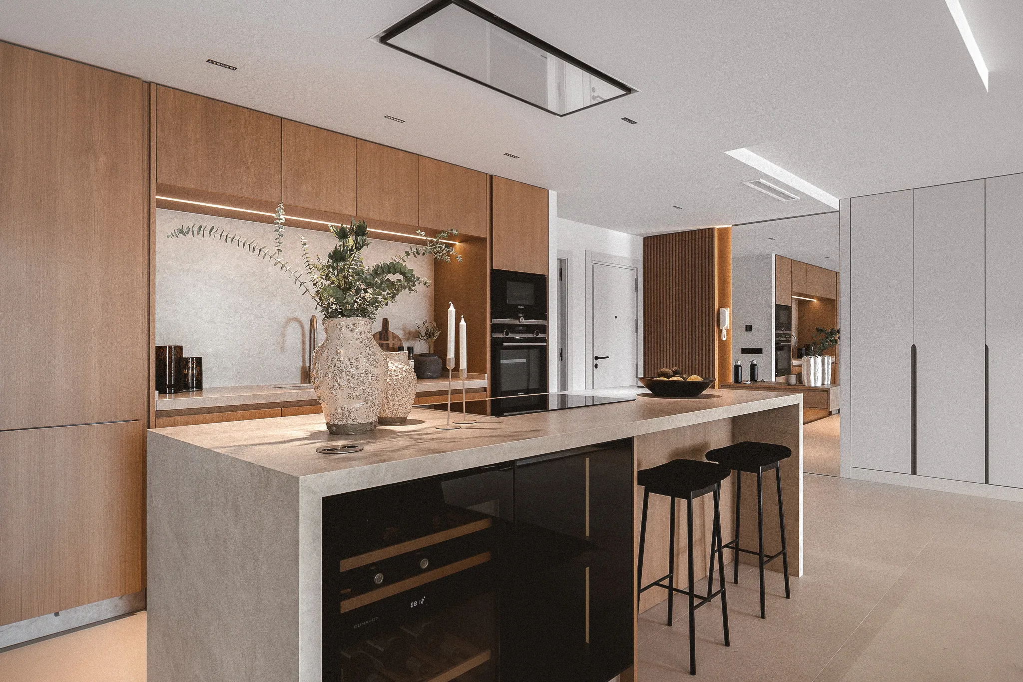 Scandinavian-inspired kitchen with natural oak cabinetry, stone island and bespoke joinery.