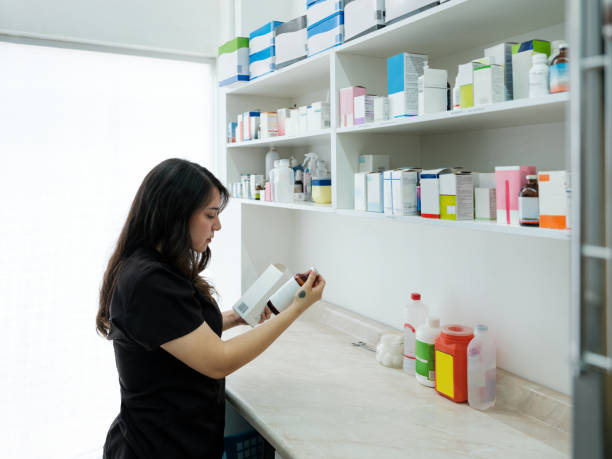 A veterinarian is getting the right medication for a pet patient at the clinic