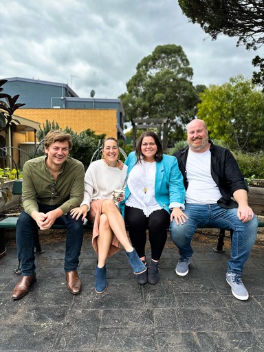 White building with red lighthouse under clear sky.